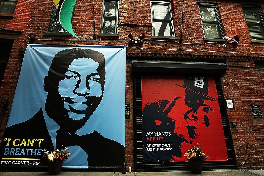 A memorial of Michael Brown, 18, next to the one of Eric Garner, is viewed outside of filmmaker's Spike Lee's 40 Acres offices | Photo: Getty Images