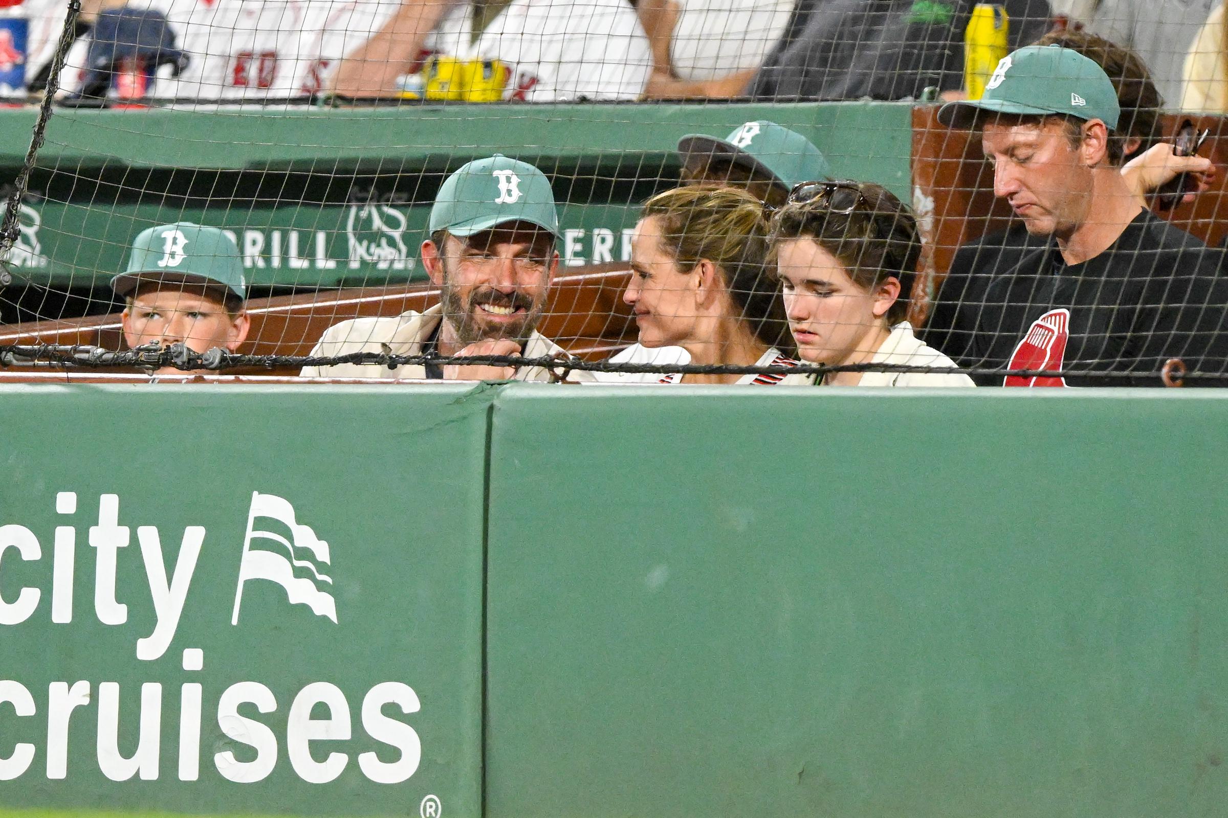 Ben Affleck and Jennifer Garner engage in a friendly conversation while watching a game with their children, Fin and Samuel, during the fourth inning between the Boston Red Sox and the Tampa Bay Rays at Fenway Park on July 11, 2025, in Massachusetts | Source: Getty Images