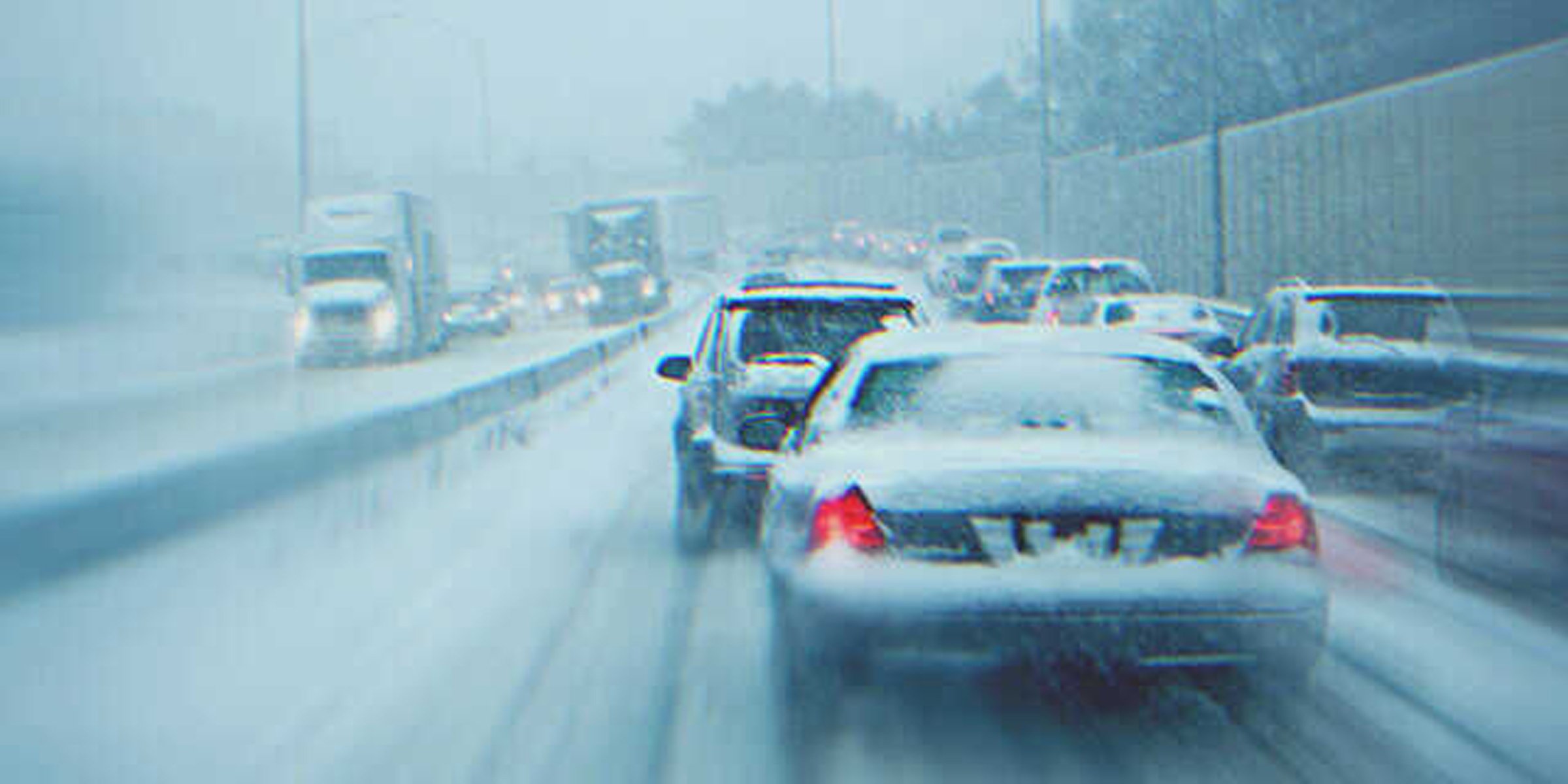 Cars on a highway during a snowstorm. | Source: Shutterstock