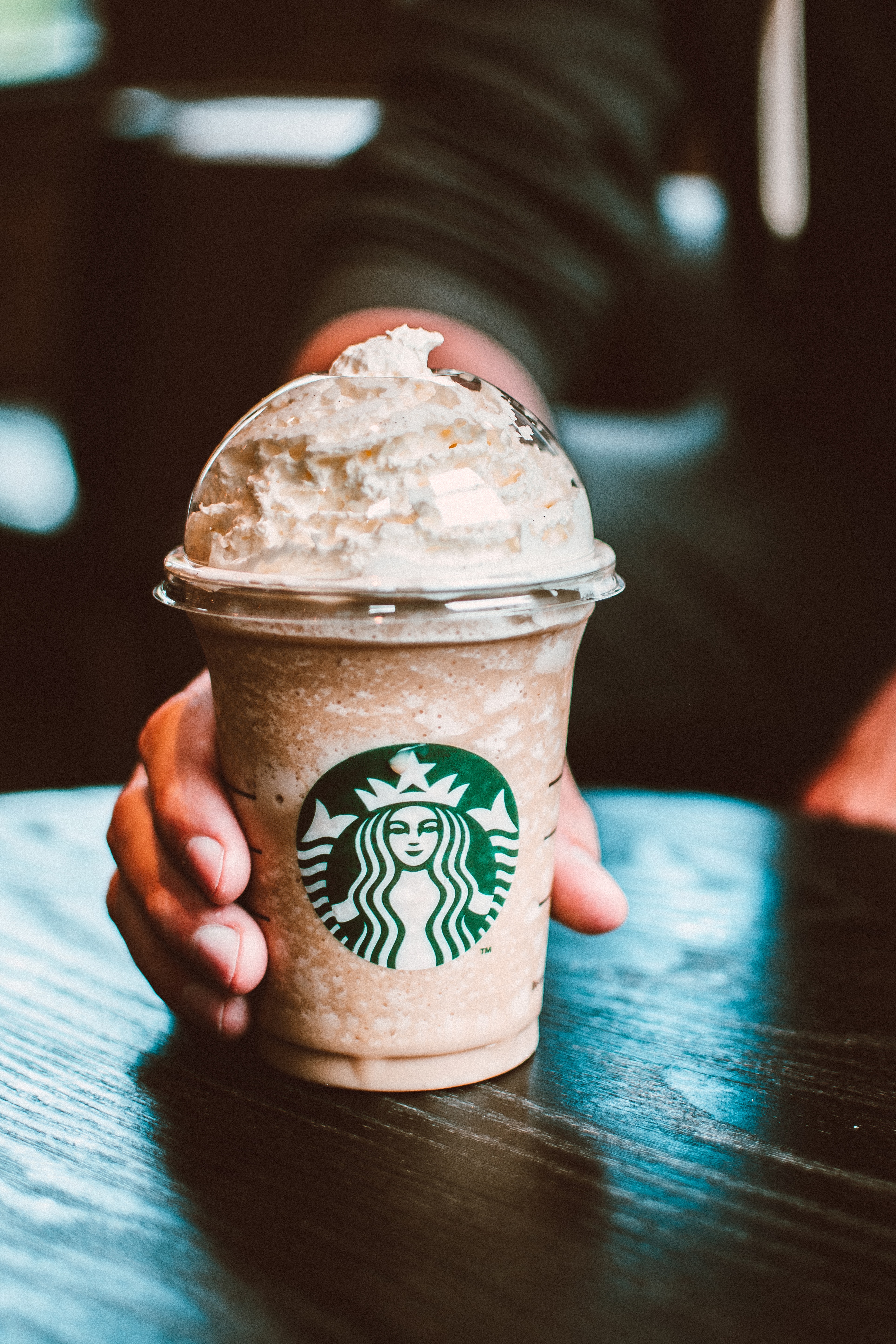 Holding a Starbucks cup | Source: Pexels