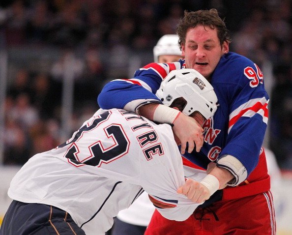 Steve MacIntyre #33 of the Edmonton Oilers fighting with Derek Boogaard #94 of the New York Rangers during a hockey game at Madison Square Garden on November 14, 2010, in New York City. | Source: Getty Images.