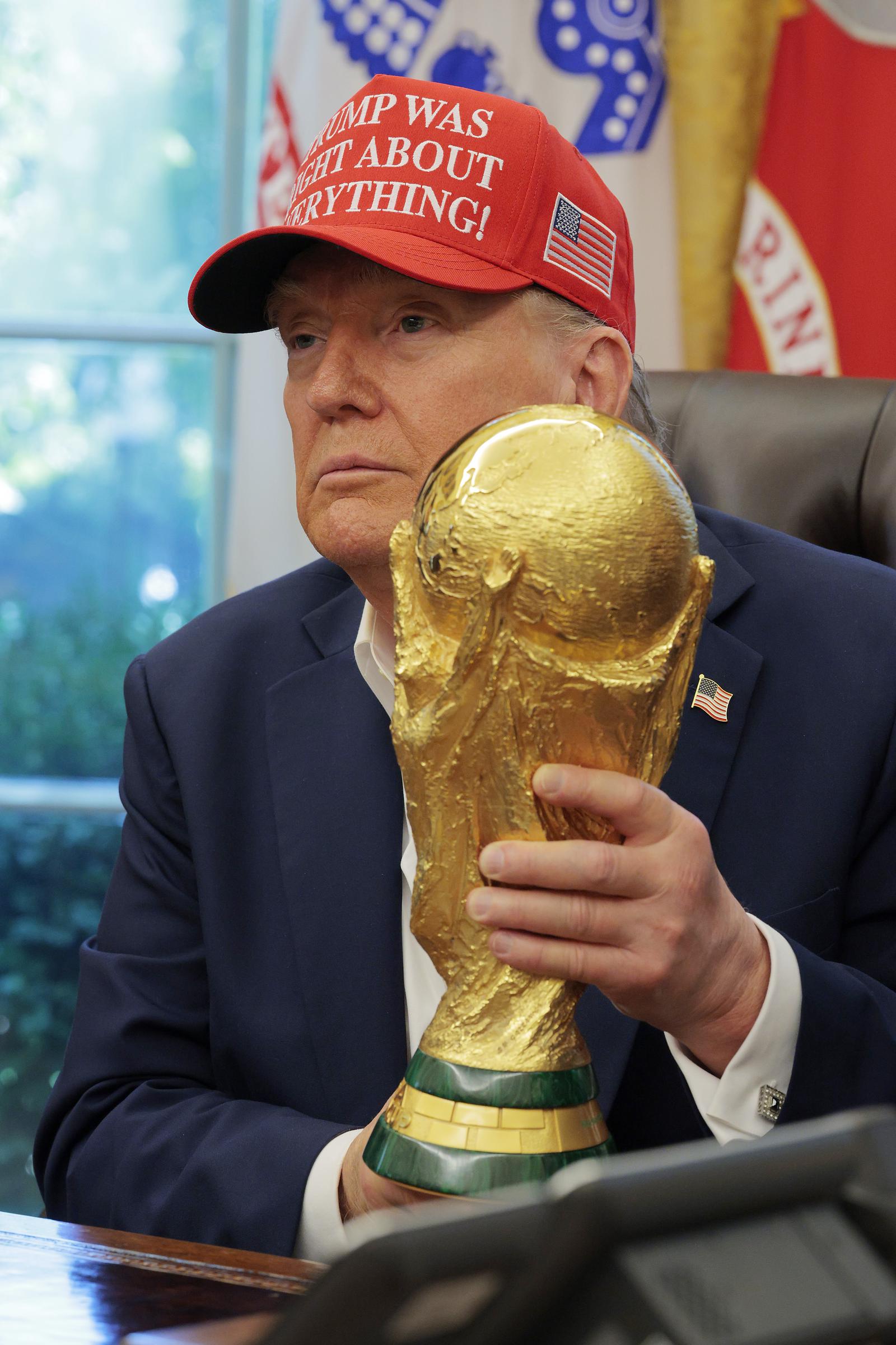 Donald Trump holds the World Cup Trophy in the Oval Office August 22, 2025 in Washington, DC. | Source: Getty Images