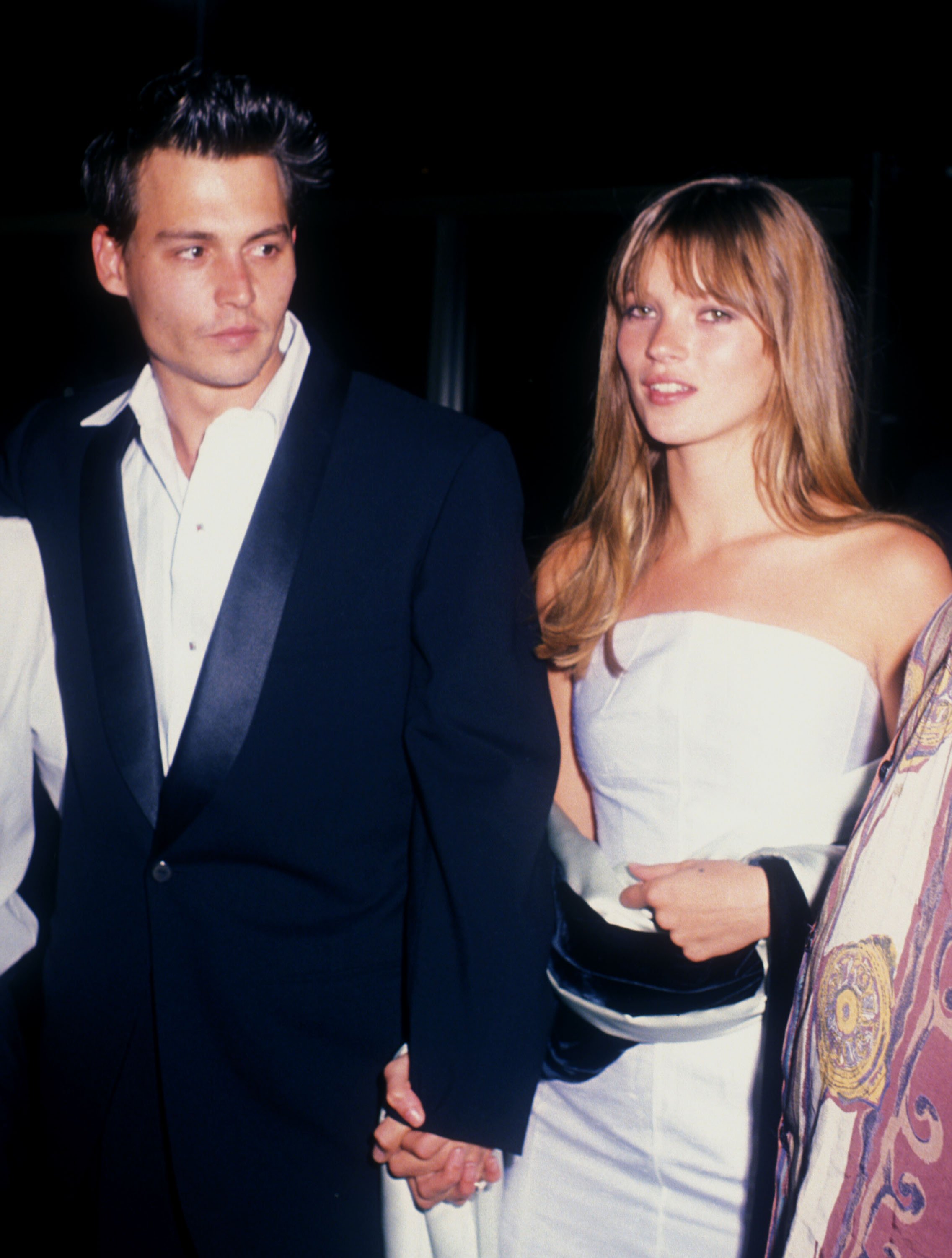 Johnny Depp holds Kate Moss's hand while walking at an undisclosed location on April 3, 1995. | Source: Getty Images
