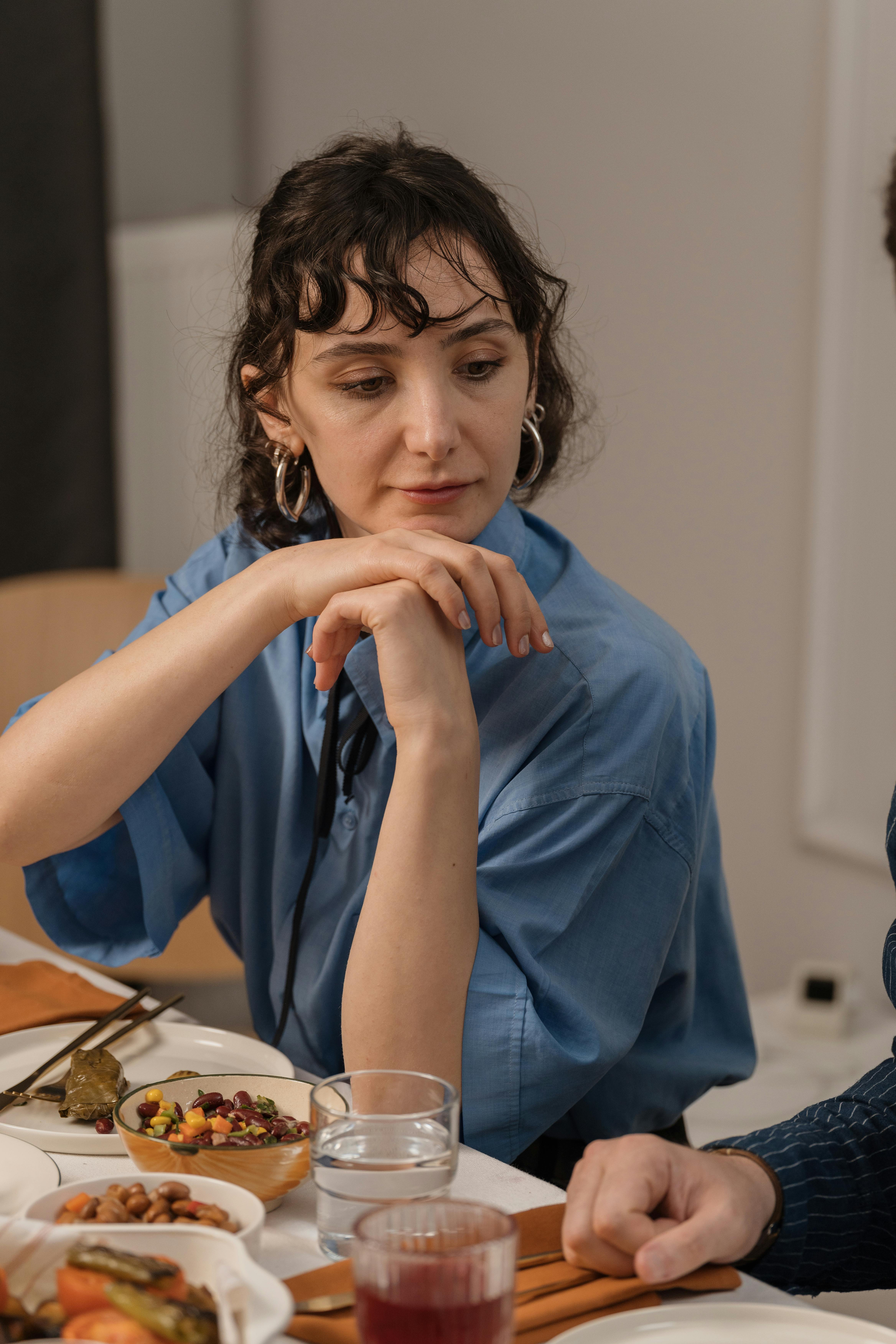 A woman sitting by the table during dinner | Source: Pexels