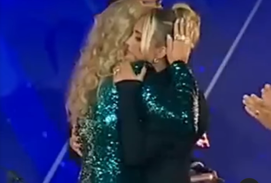Erika Kirk pats Brittany Aldean's head as they hug during the 2025 Fox Nation Patriot Awards | Source: Instagram/the.independent