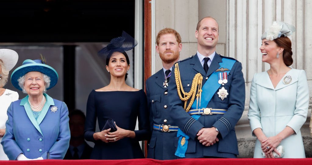 Queen Elizabeth, Meghan Markle, Prince Harry, Prince William, and Prince William stand on the balcony at Buckingham Palace to watch the flypast marking the centenary of the Royal Air Force on July 10, 2018, in London, England | Source: Max Mumby/Indigo/Getty Images