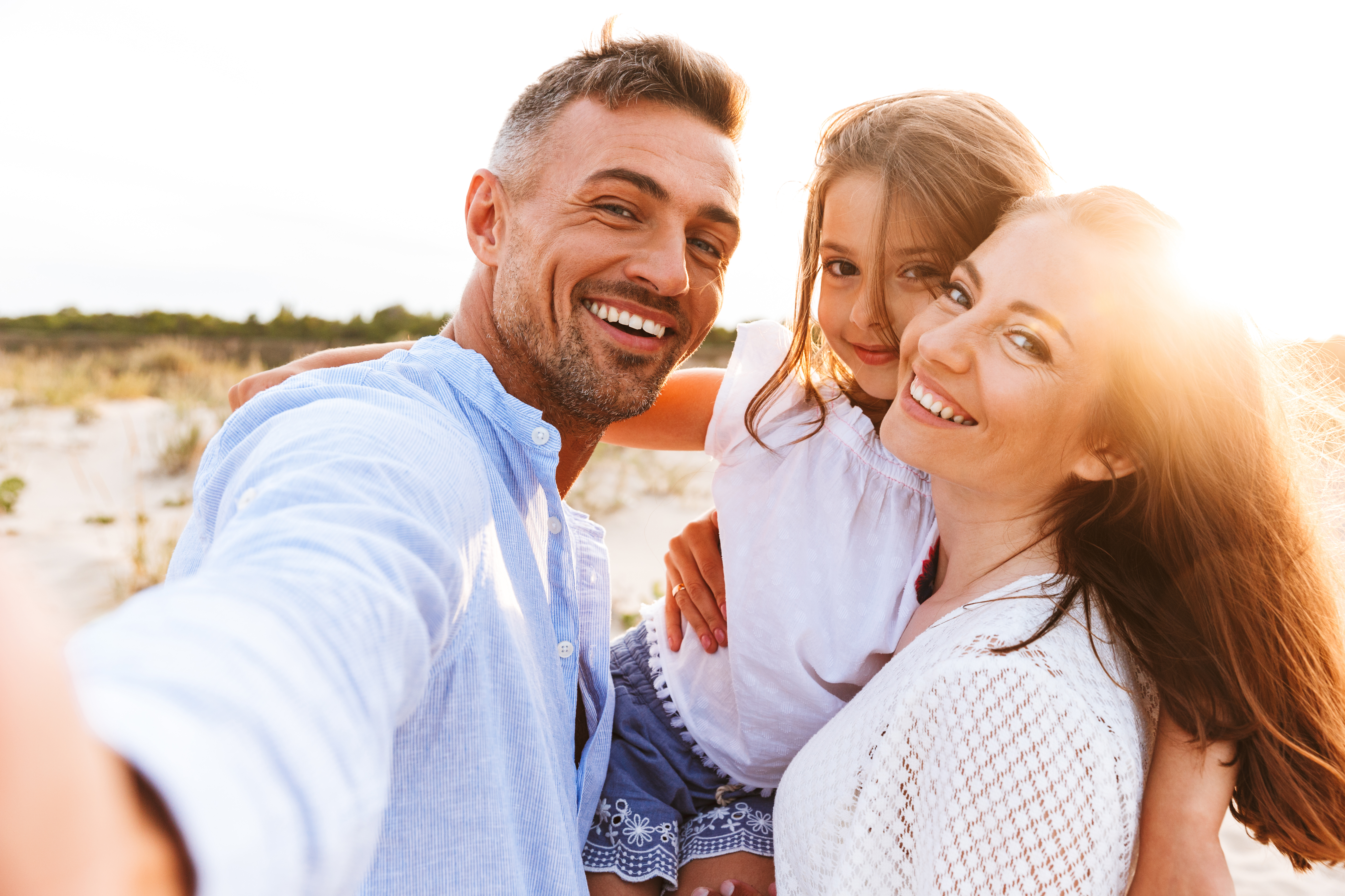 A family of three at the beach | Source: Shutterstock