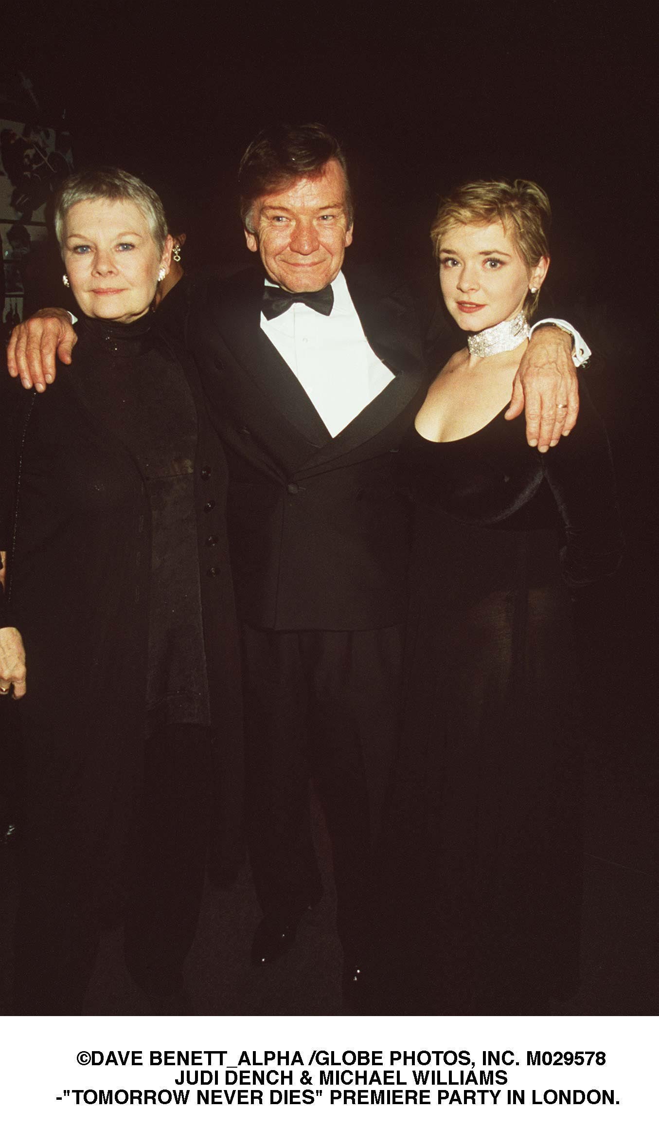 Judi Dench, Michael Williams, and their daughter Finty Williams at the world gala premiere of "Tomorrow Never Dies" on December 9, 1997, in London | Source: Getty Images