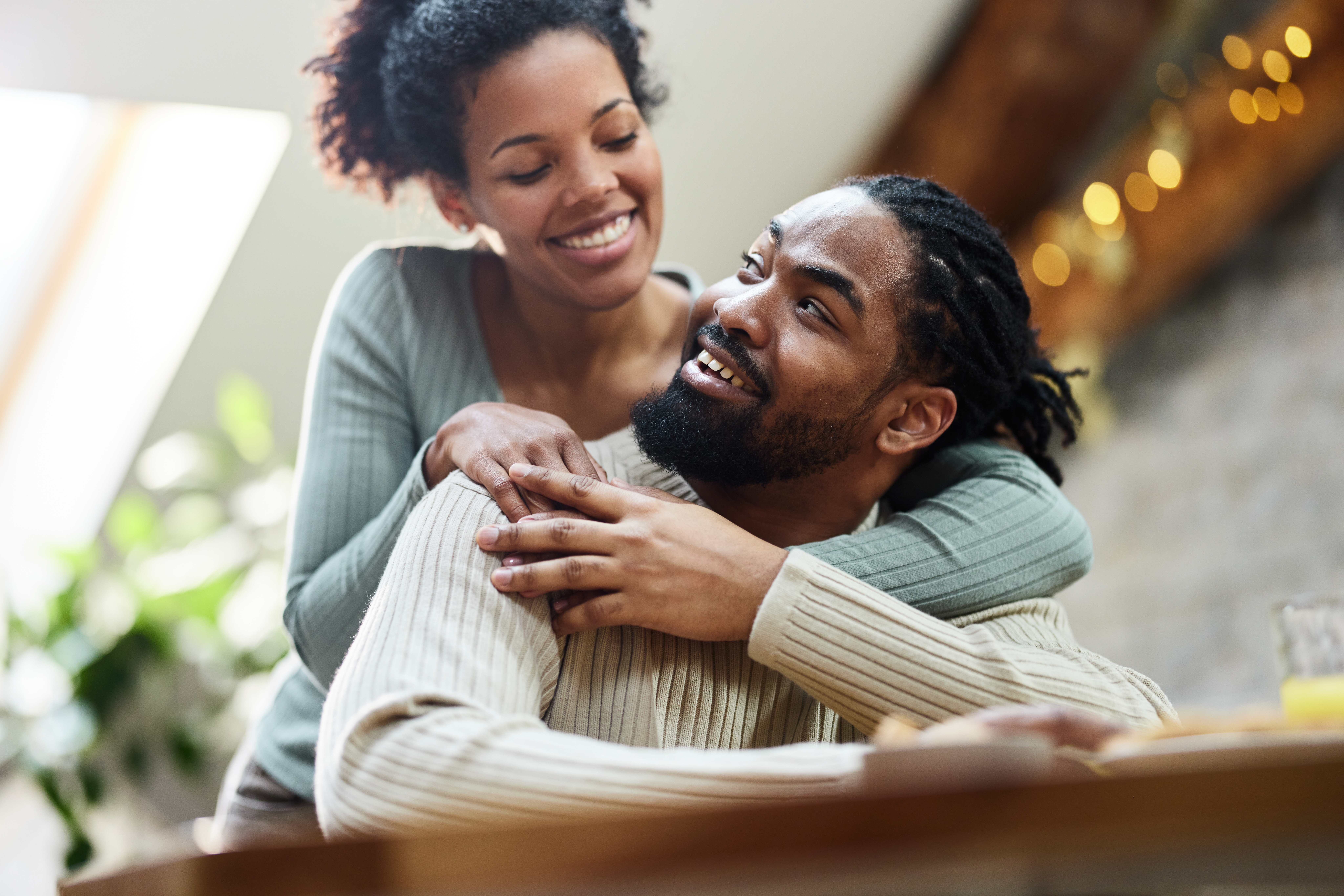 Happy black couple talking during morning at home | Source: Getty Images