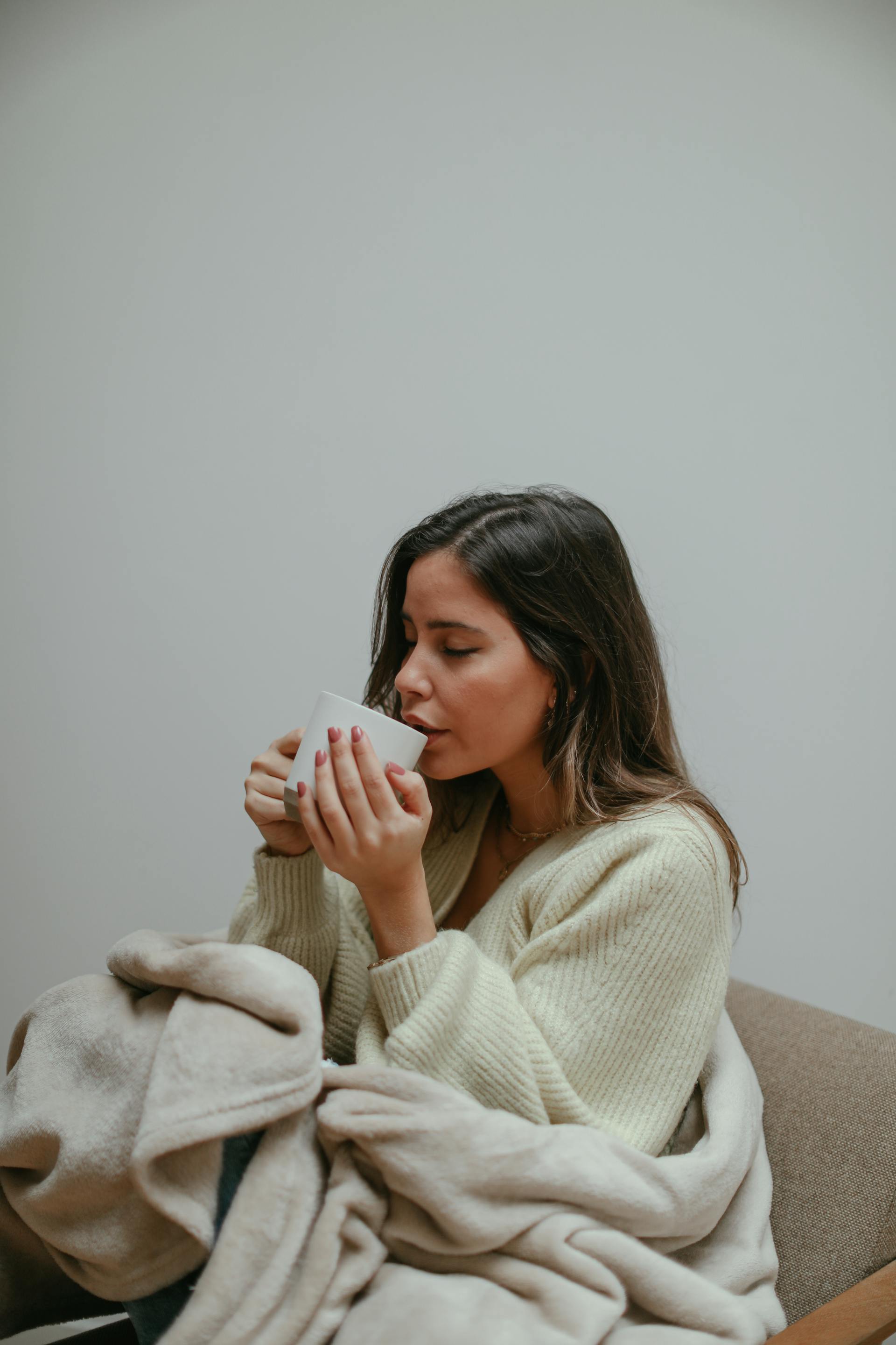 A woman drinking from a mug | Source: Pexels