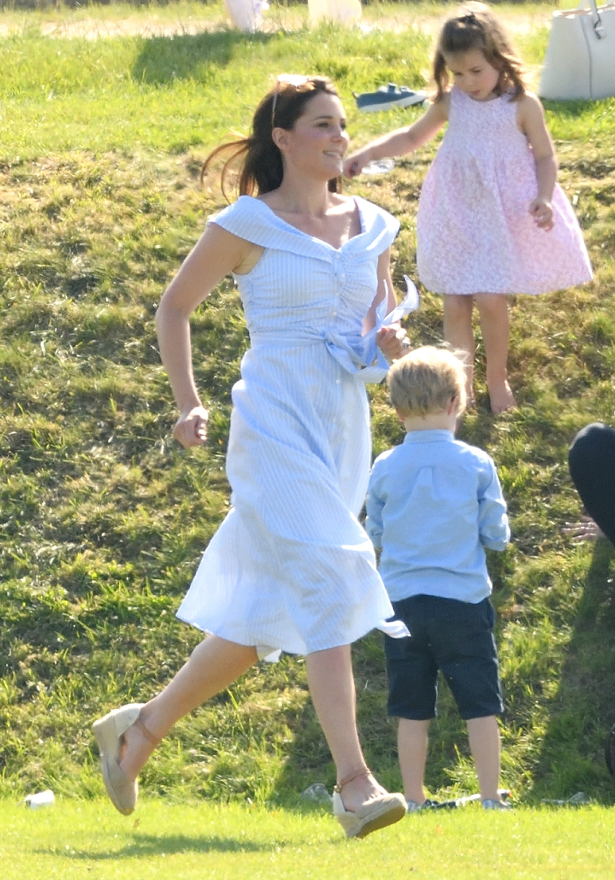 On 10 June 2018, Catherine, Princess of Wales, mirrored the playful spirit of her late mother-in-law as she ran barefoot across the grass at the Maserati Royal Charity Polo Trophy in Gloucester. Wearing a light summer dress and a wide smile, she chased after her children with carefree energy, echoing a royal tradition of being a mom first.