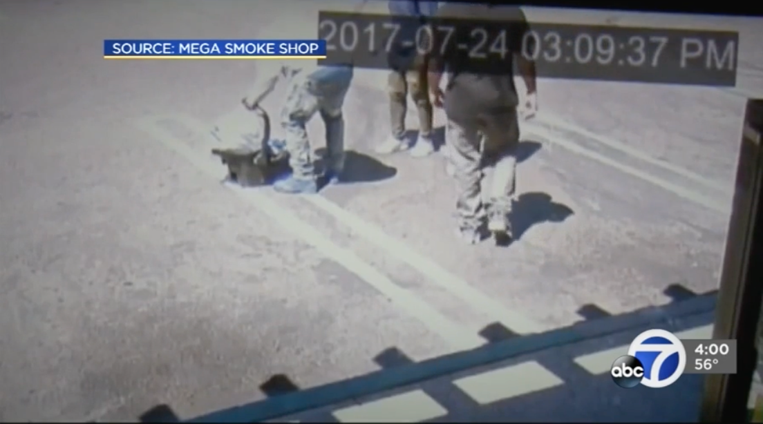 Passersby are spotted near the car seat, with one man picking it up | Source: YouTube.com/KCRA 3