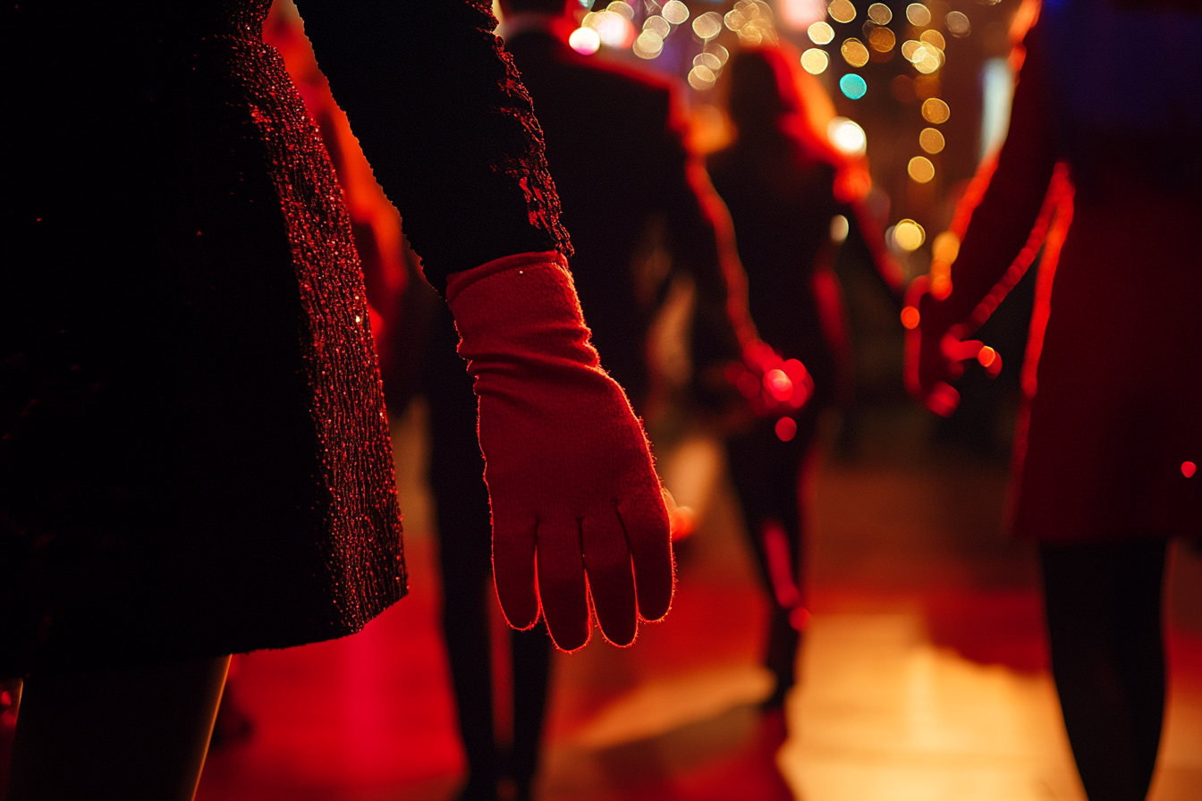 Close-up of a person at a party wearing a red glove | Source: AmoMama