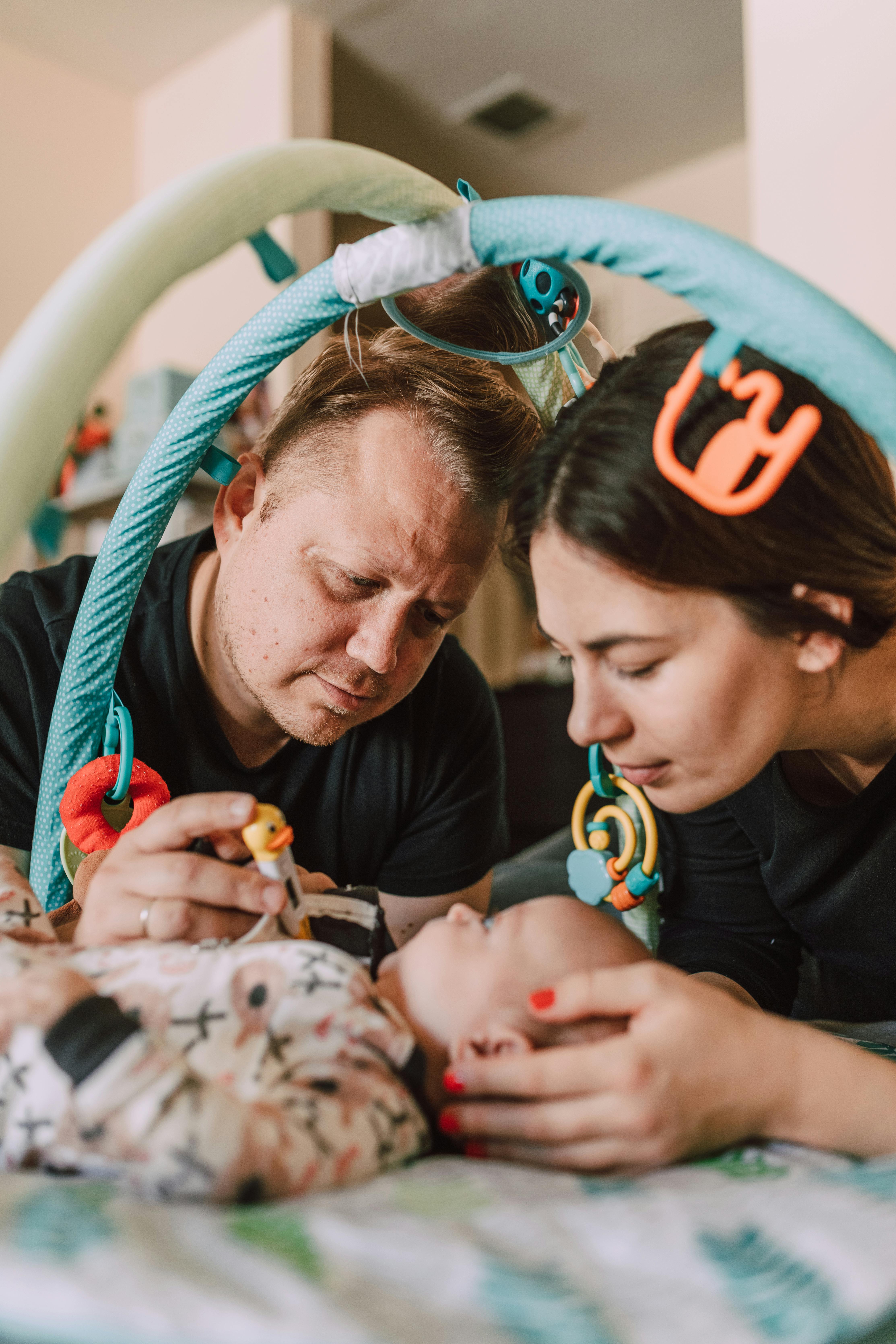 A couple playing with their baby | Source: Pexels