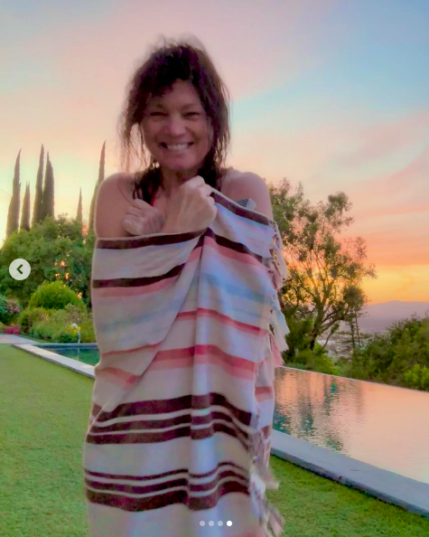 Valerie Bertinelli smiling widely by her pool, while wrapped in a towel/blanket, posted on April 30, 2025. | Source: Instagram/wolfiesmom