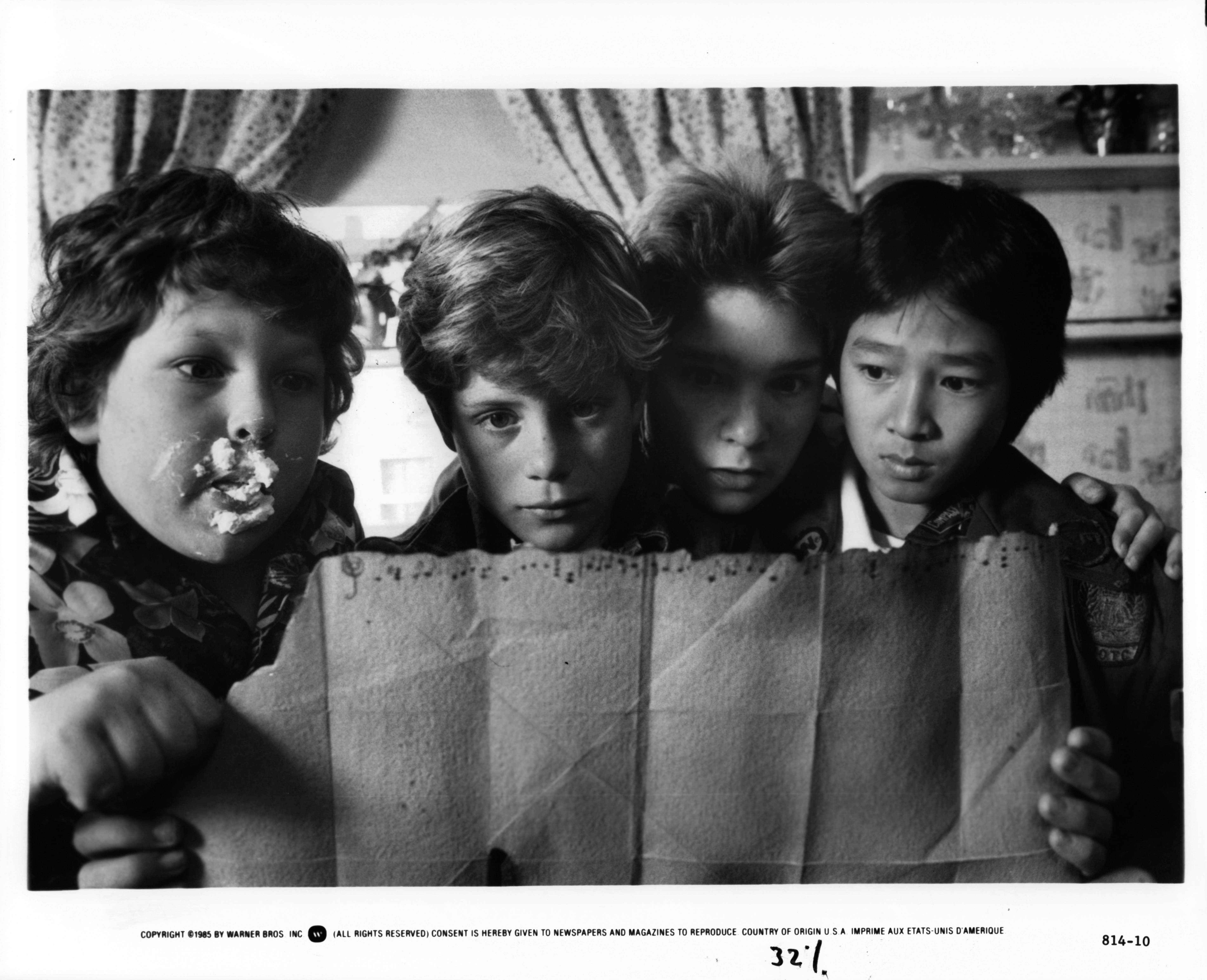 (L-R) Jeff Cohen, Sean Astin, Corey Feldman, and Ke Huy Quan are pictured in a scene from the film, 'The Goonies', in 1985 | Source: Getty Images