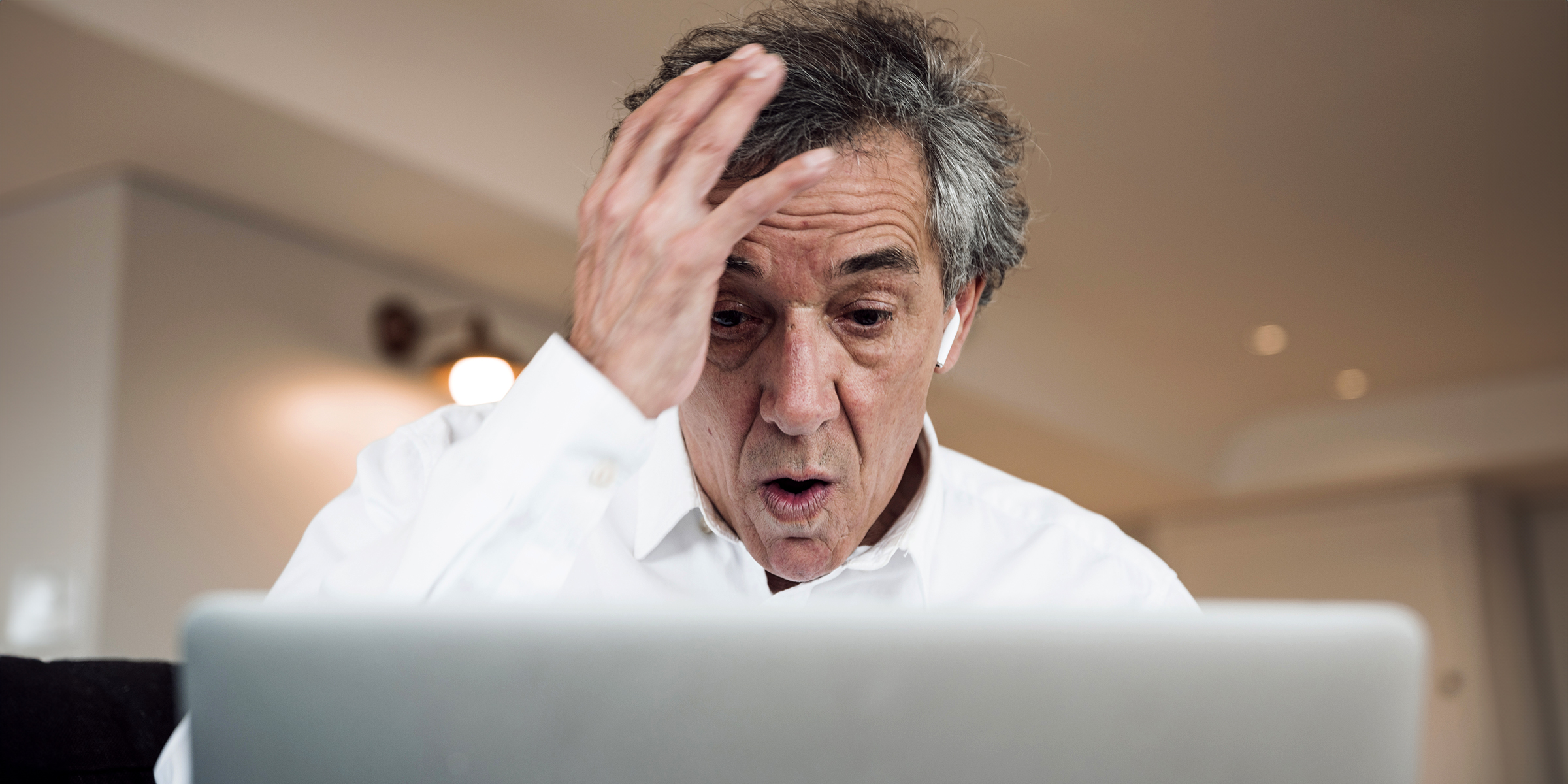 A man shocked during a Zoom meeting | Source: Freepik