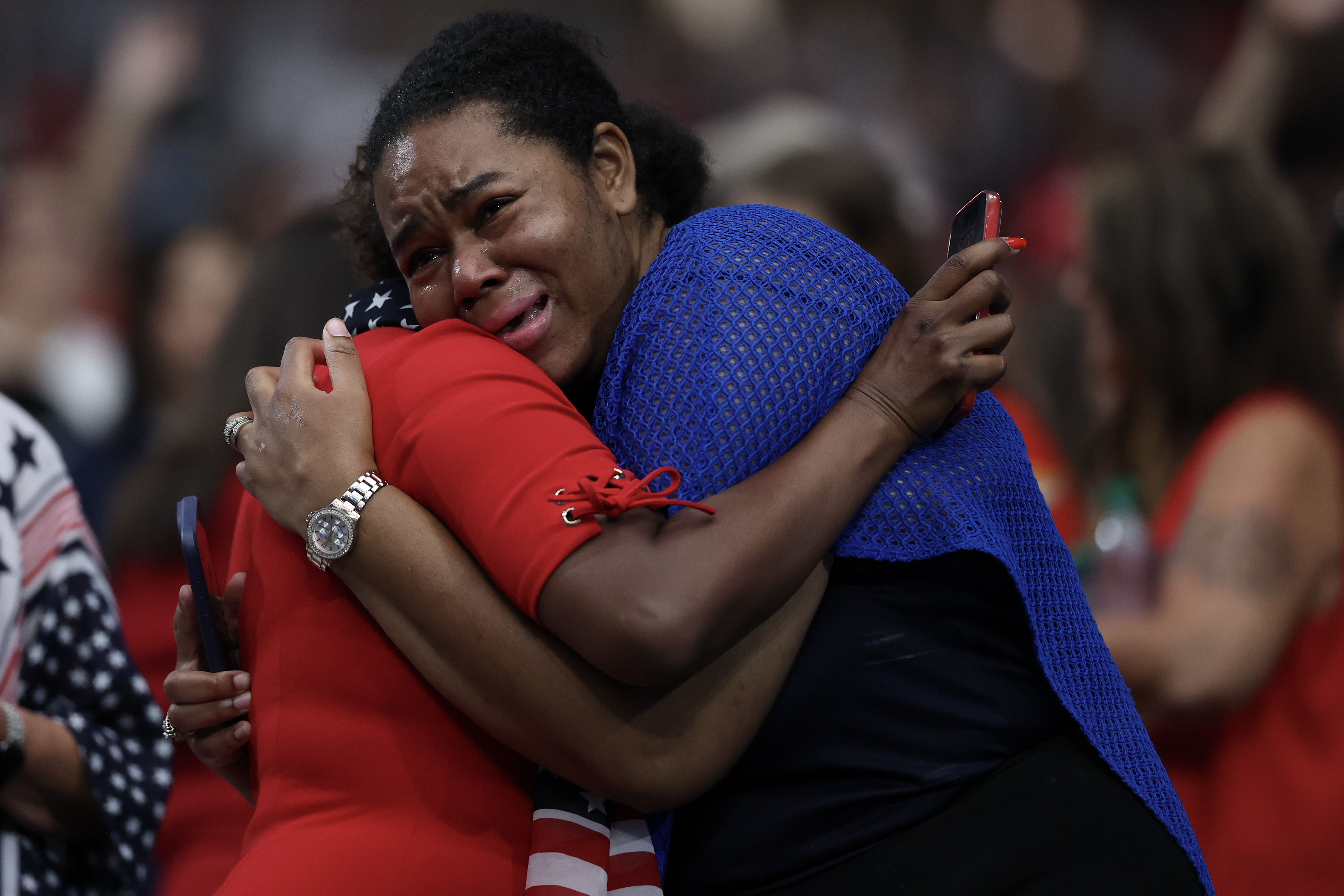 Mourners comfort each other during the memorial service for Charlie Kirk at State Farm Stadium on September 21, 2025 in Glendale, Arizona | Source: Getty Images