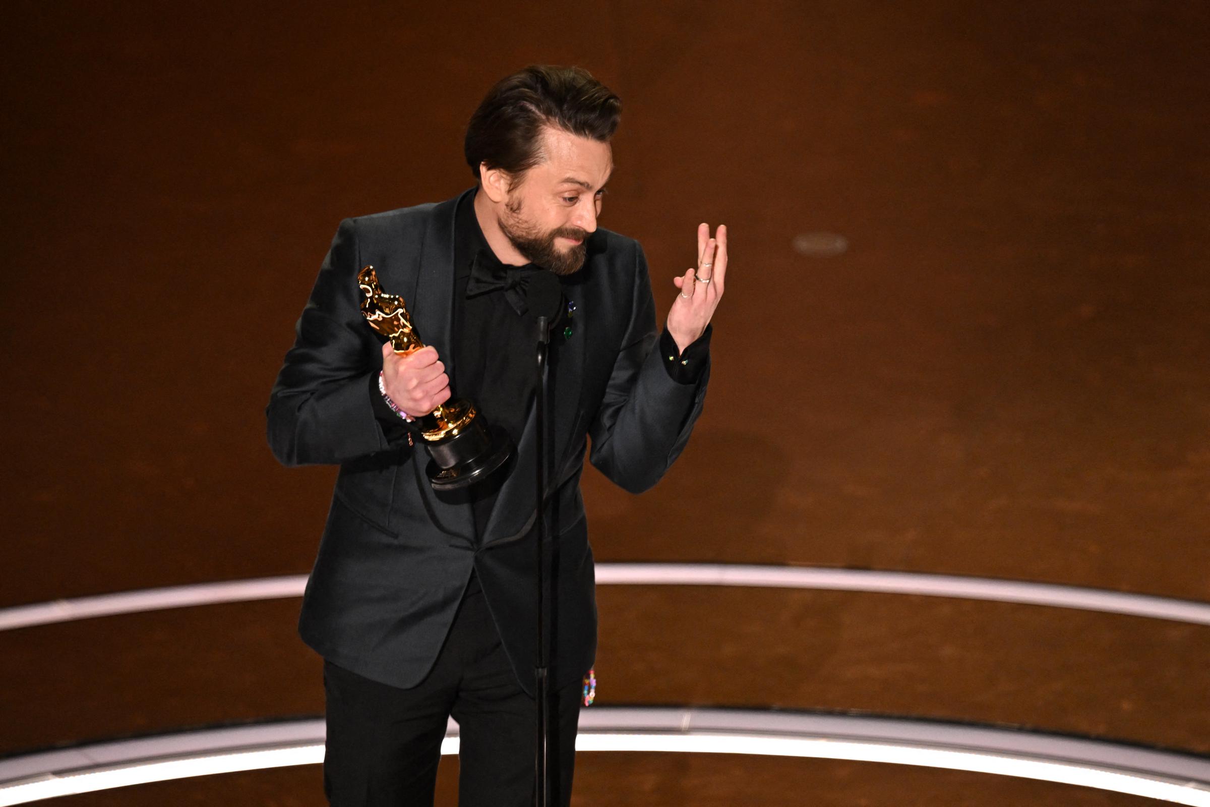Kieran Culkin gestures to his wife in the crowd as he accepts the award for Best Supporting Actor for "A Real Pain" during the 97th Annual Academy Awards in Hollywood, California, on March 2, 2025 | Source: Getty Images