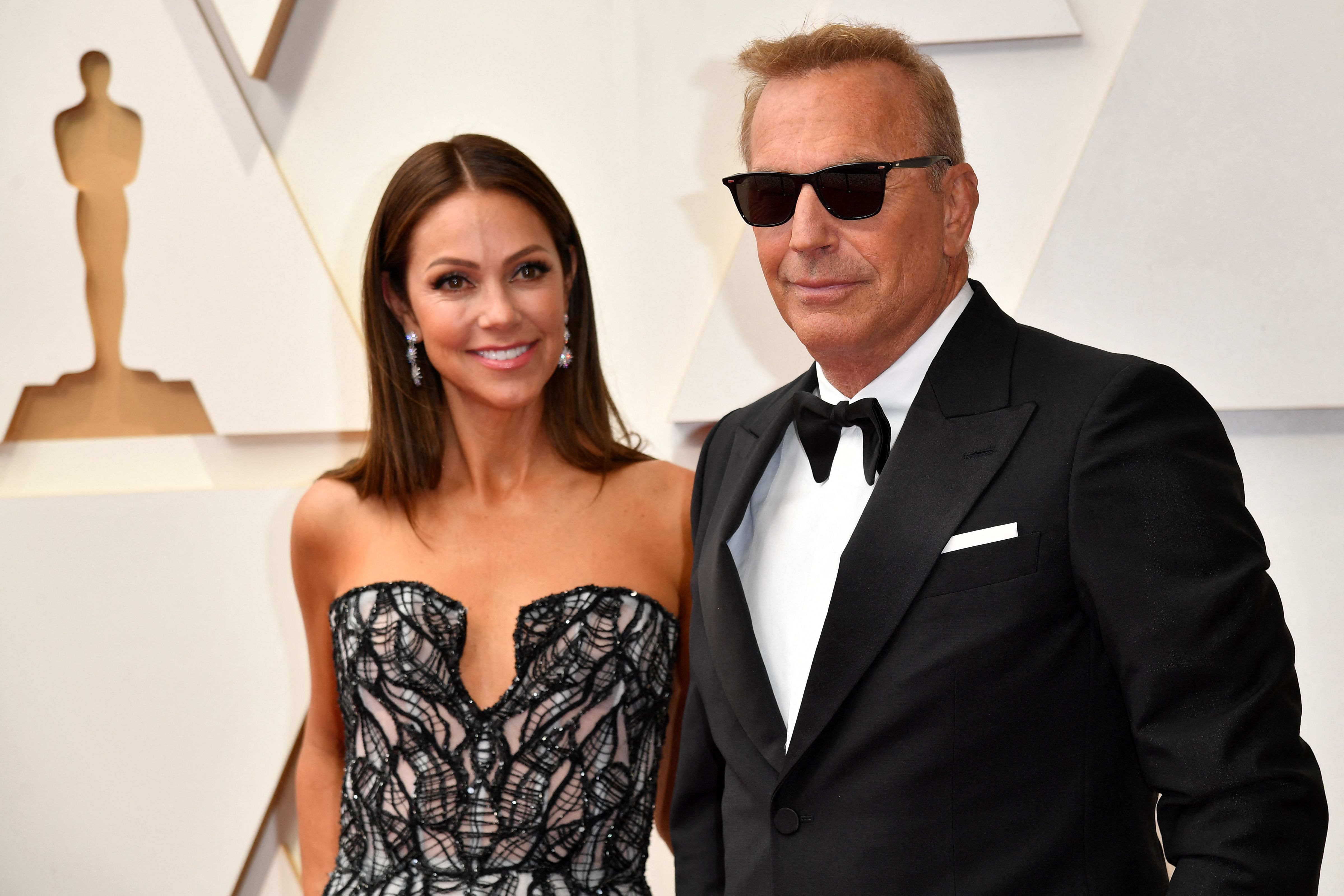 Kevin Costner and Christine Baumgartner at the 94th Oscars on March 27, 2022 | Source: Getty Images