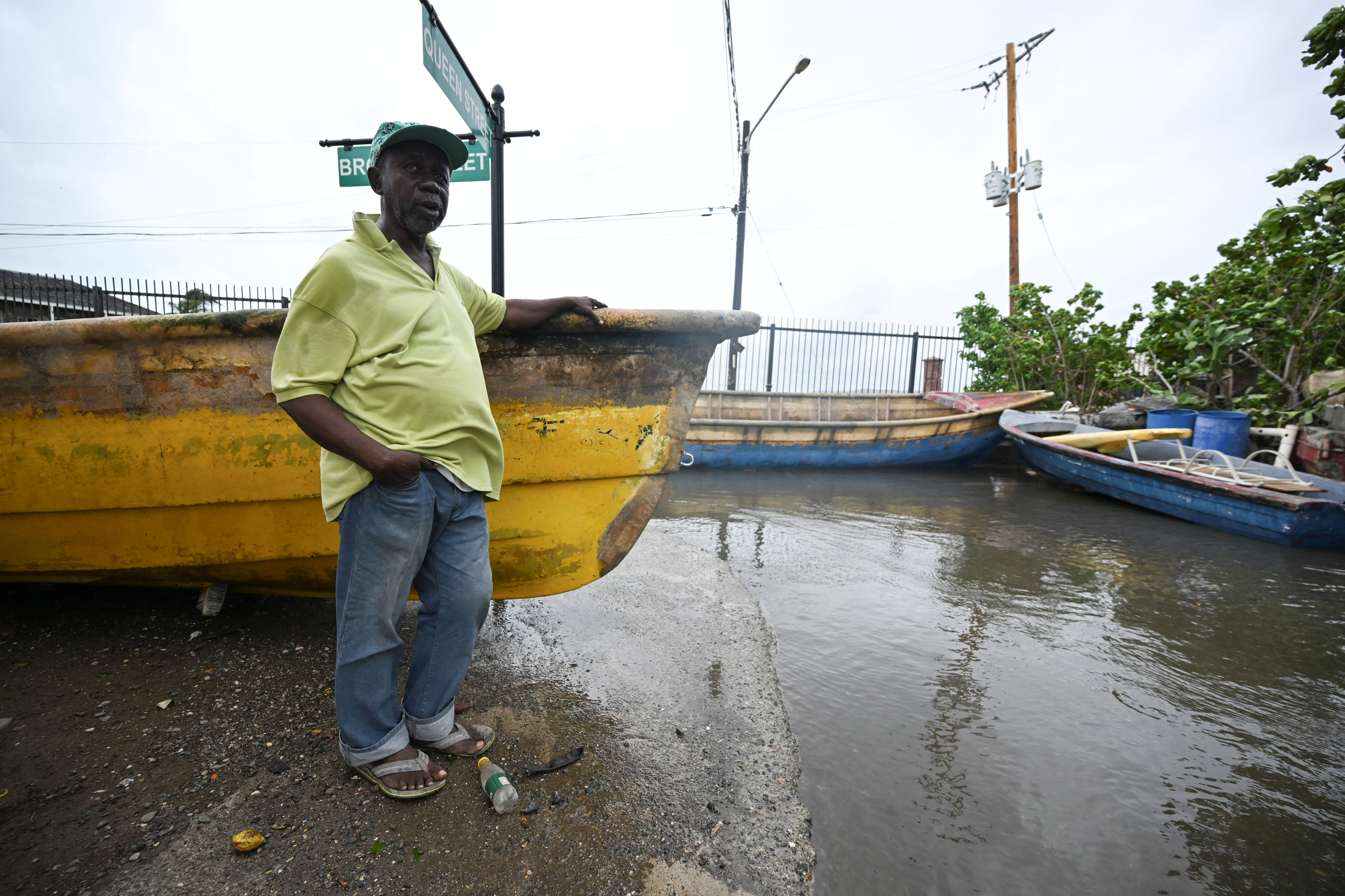A resident stands at a flooded section of Port Royal in Kingston on October 27, 2025 | Source: Getty Images