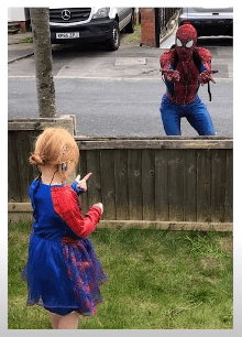 Jason Baird from Stockport pictured cheering up a young girl in his Spider-Man suit, 2020, England. | Photo: Getty Images