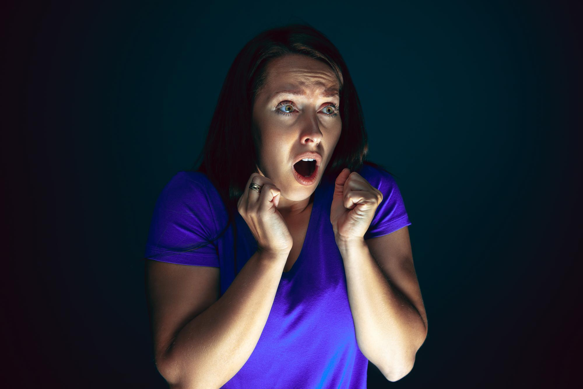 A woman reacting in shock to something | Source: Freepik