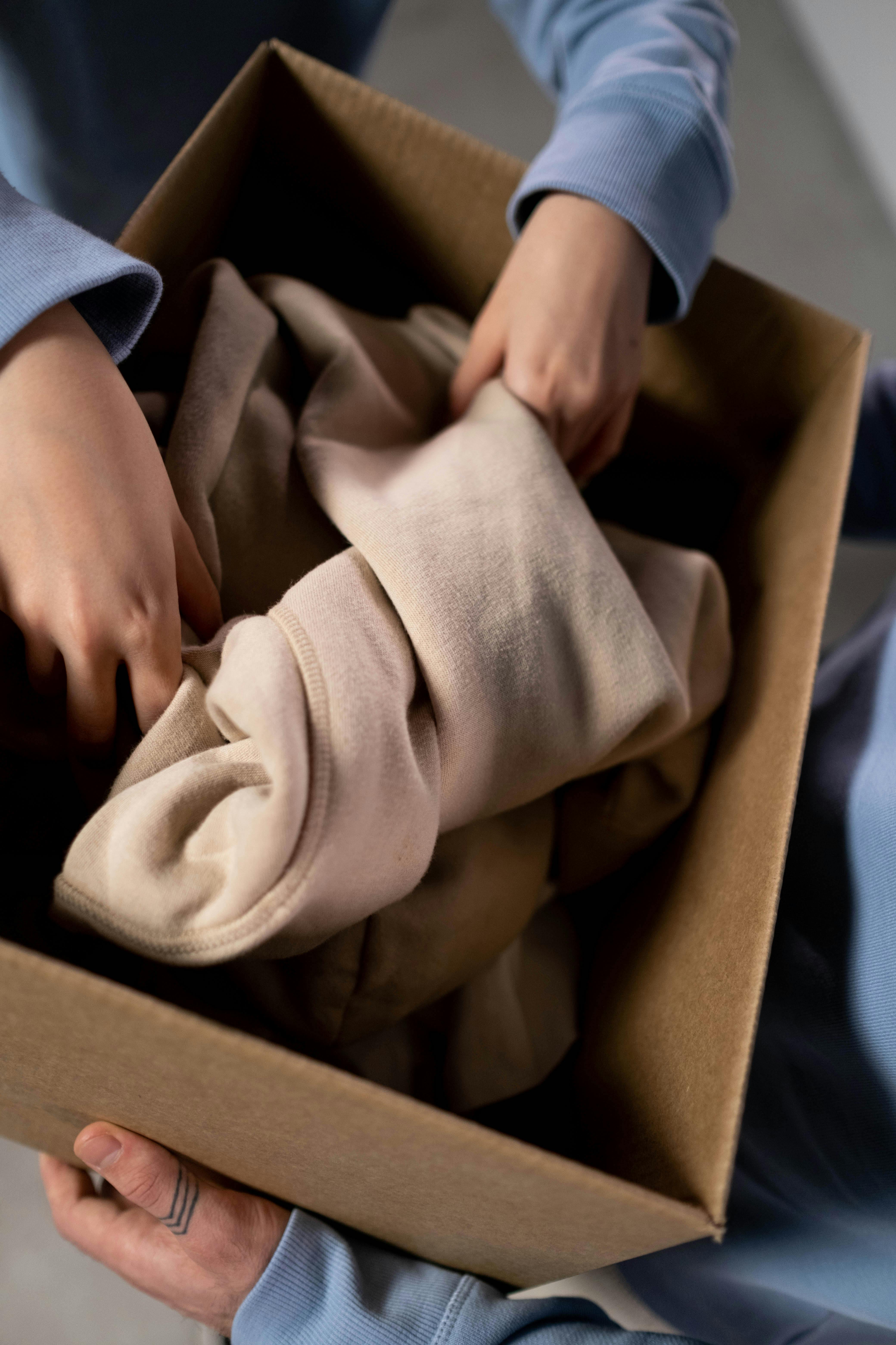 Woman sorting through donations | Source: Pexels