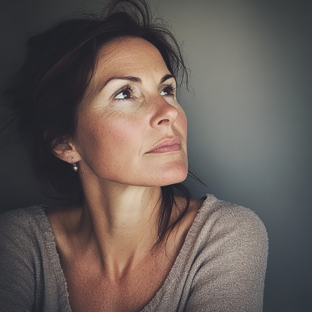 A pensive woman in her forties | Source: Midjourney