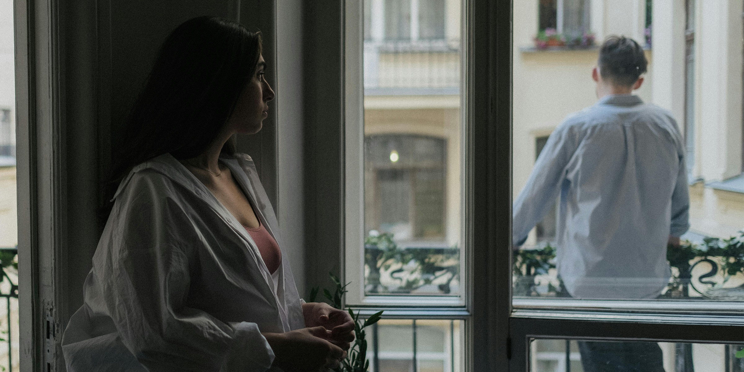 Woman watching a man on a balcony | Source: Pexels