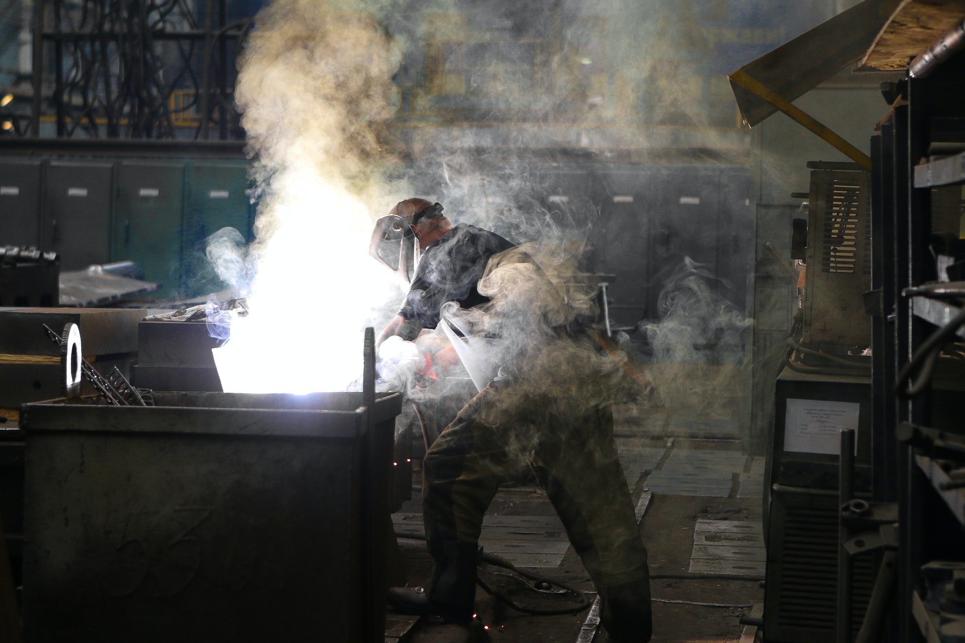A man wearing welding mask covered in welding smoke | Source: Pexels