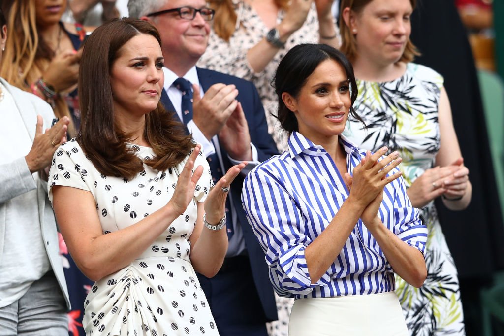 Catherine, Duchess of Cambridge and Meghan, Duchess of Sussex applaud ahead of the Ladies' Singles final match between Serena Williams of The United States and Angelique Kerber of Germany on day twelve of the Wimbledon Lawn Tennis Championships at All England Lawn Tennis and Croquet Club on July 14, 2018 | Photo: Getty Images