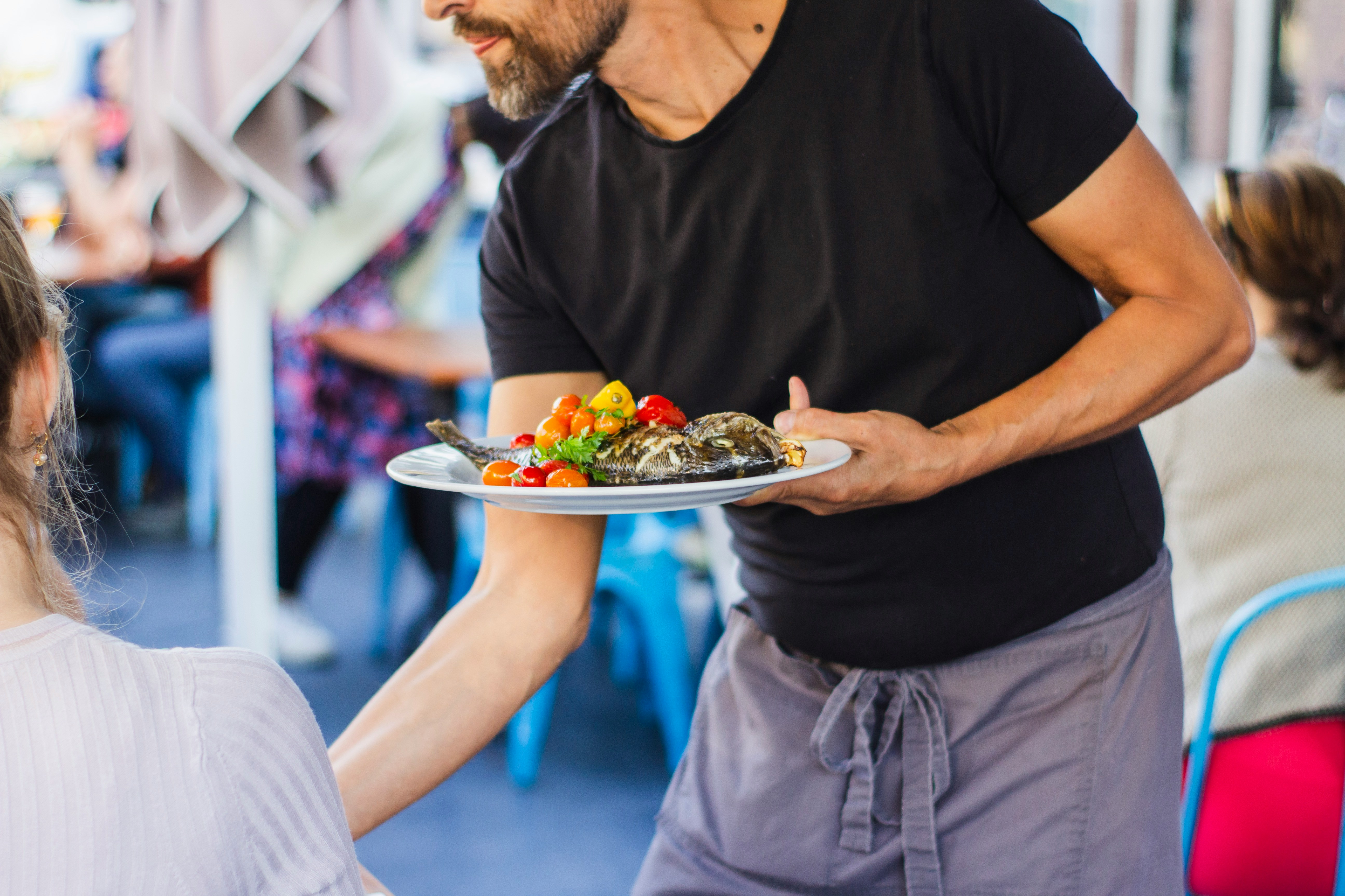 Waiter serving a customer | Source: Unsplash