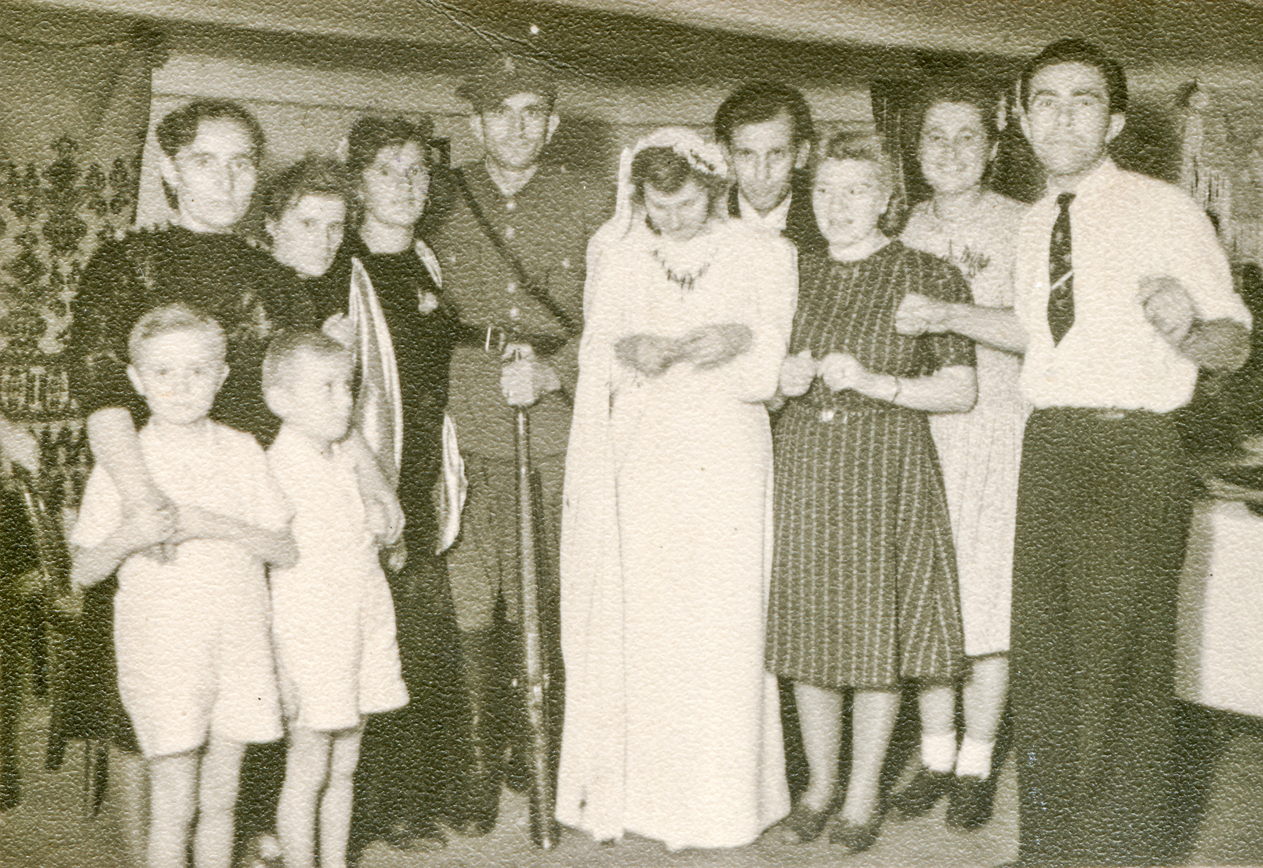 Newlyweds on their wedding day alongside family  | Source: Shutterstock