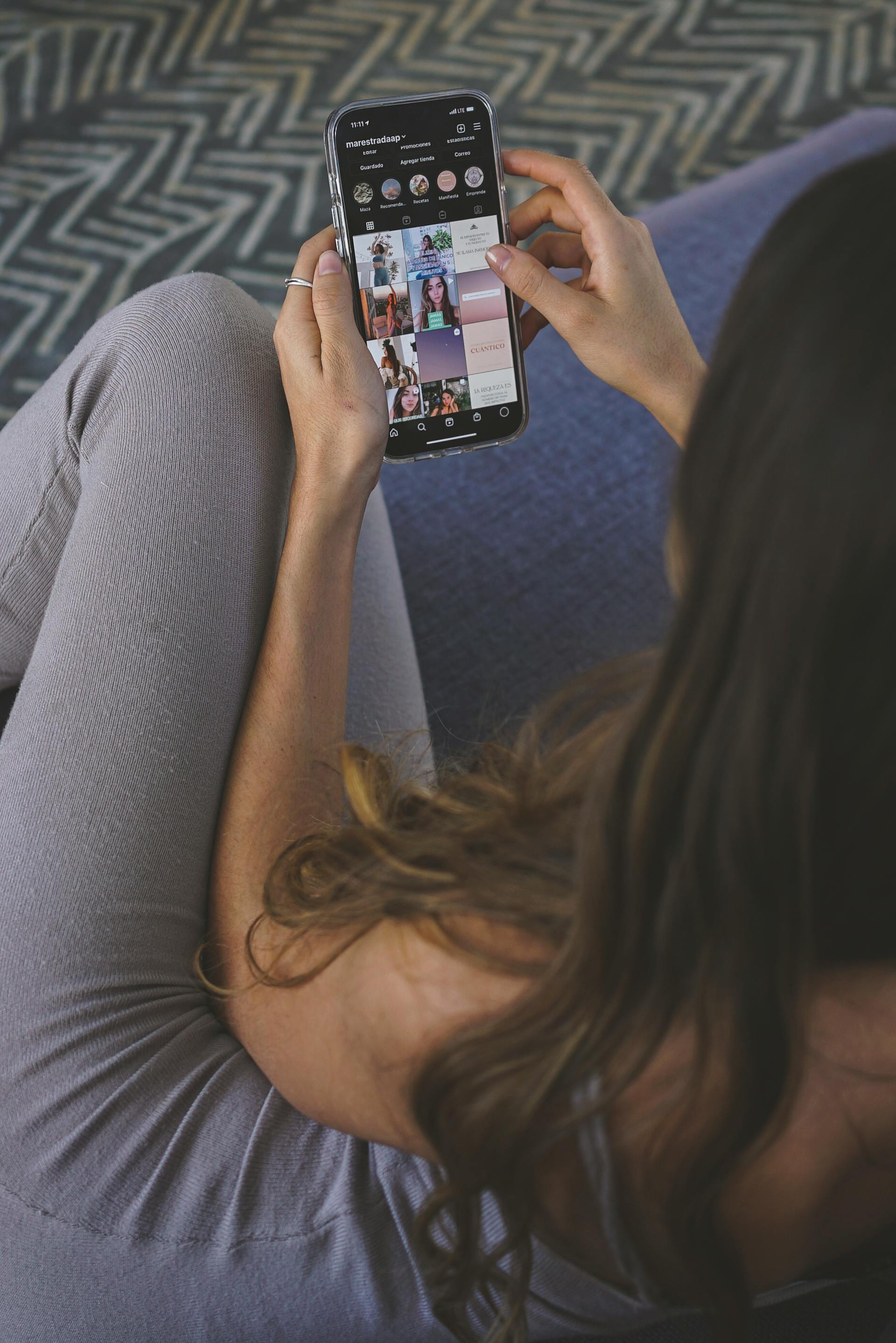 A woman seeing pictures on her smartphone | Source: Pexels