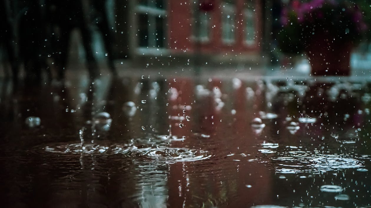 The rain was falling heavily, and a wet man was right outside her door. | Source: Pexels