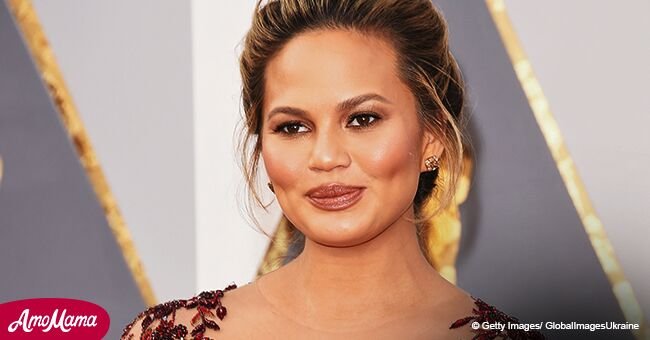 Chrissy Teigen refuses to reveal who bit Beyoncе as she flashes growing baby bump in a floral print dress