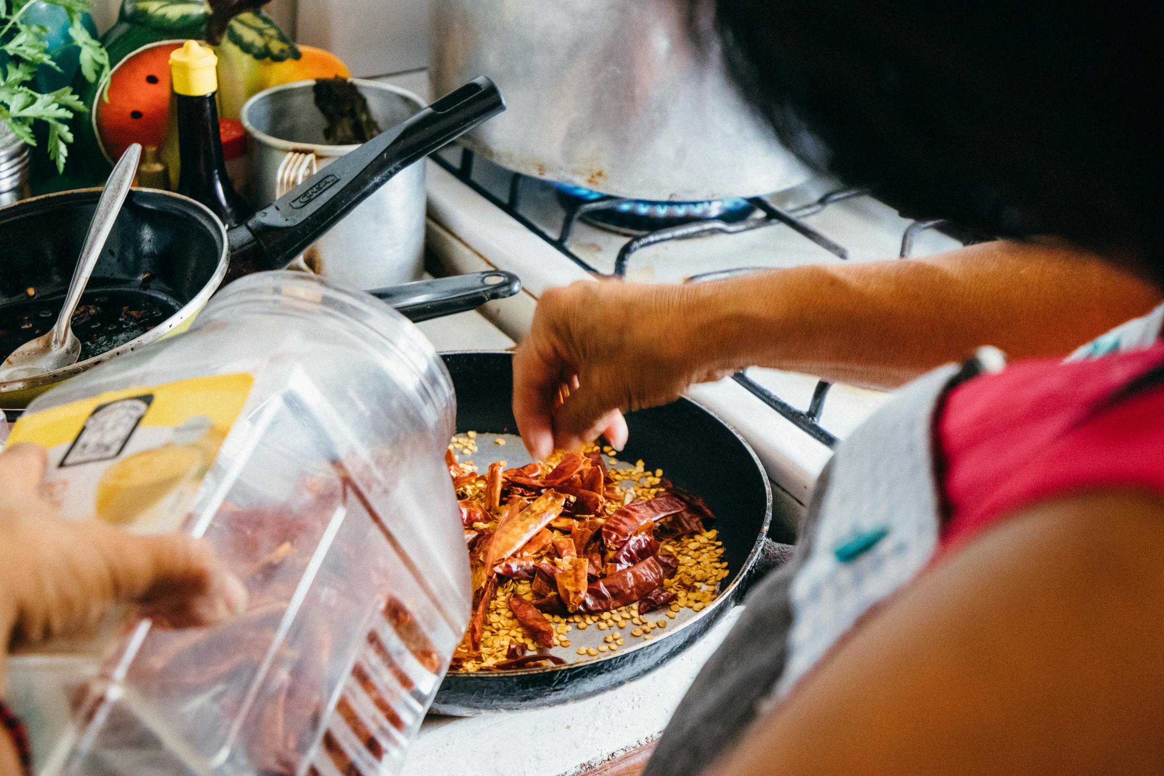 A woman making chili | Source: Unsplash