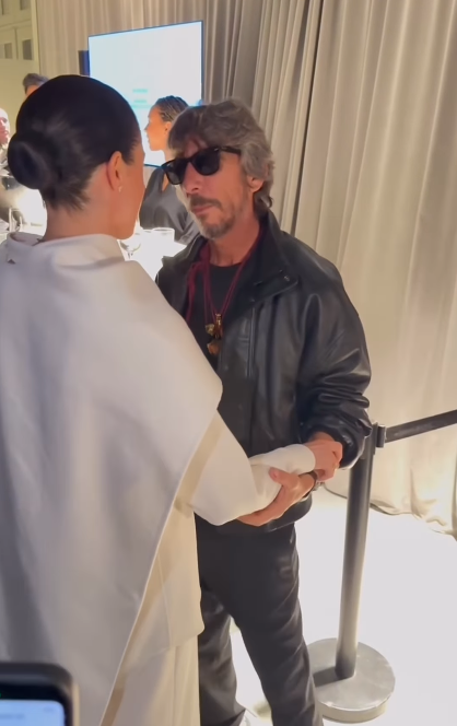 Meghan Markle and designer Pierpaolo Piccioli talking and touching at Paris Fashion Week on October 4, 2025 | Source: Instagram/wwd