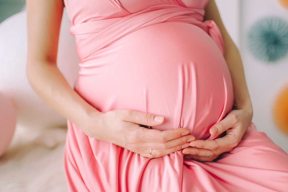 Pregnant woman holding her belly. | Source: Shutterstock