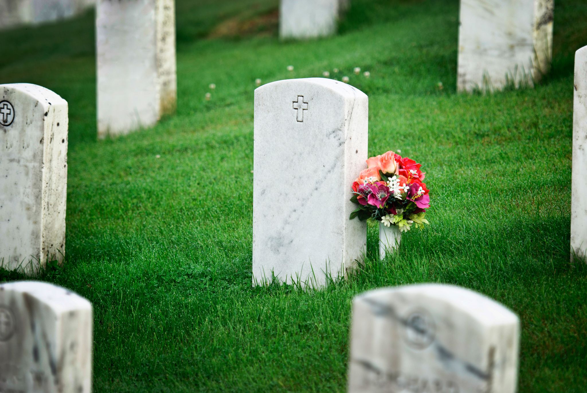 A tombstone with flowers. | Source: Getty Images