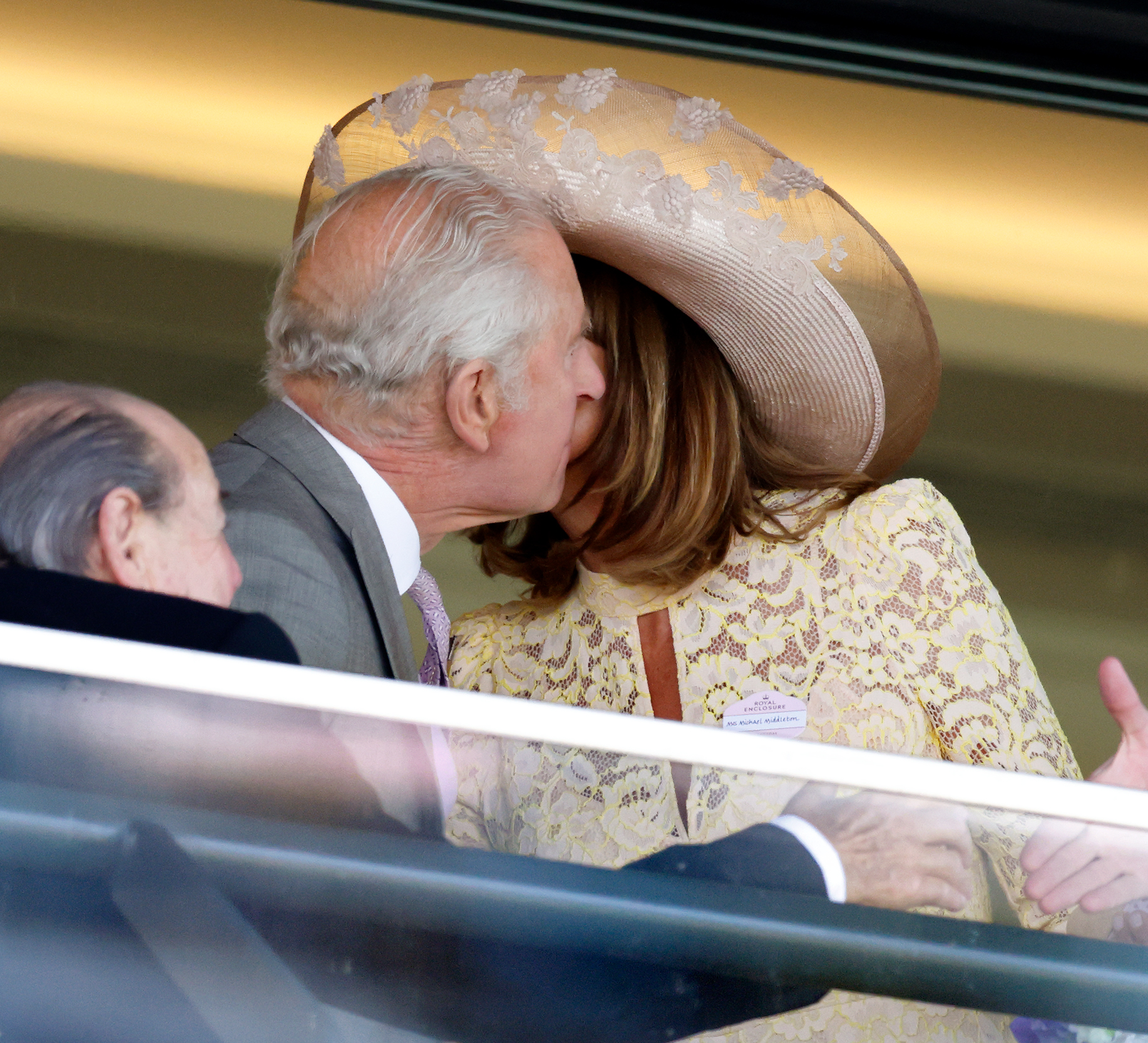 King Charles III shares a kiss on the cheek with Carole Middleton in the royal box during day two of Royal Ascot on June 18, 2025, in Berkshire, England.