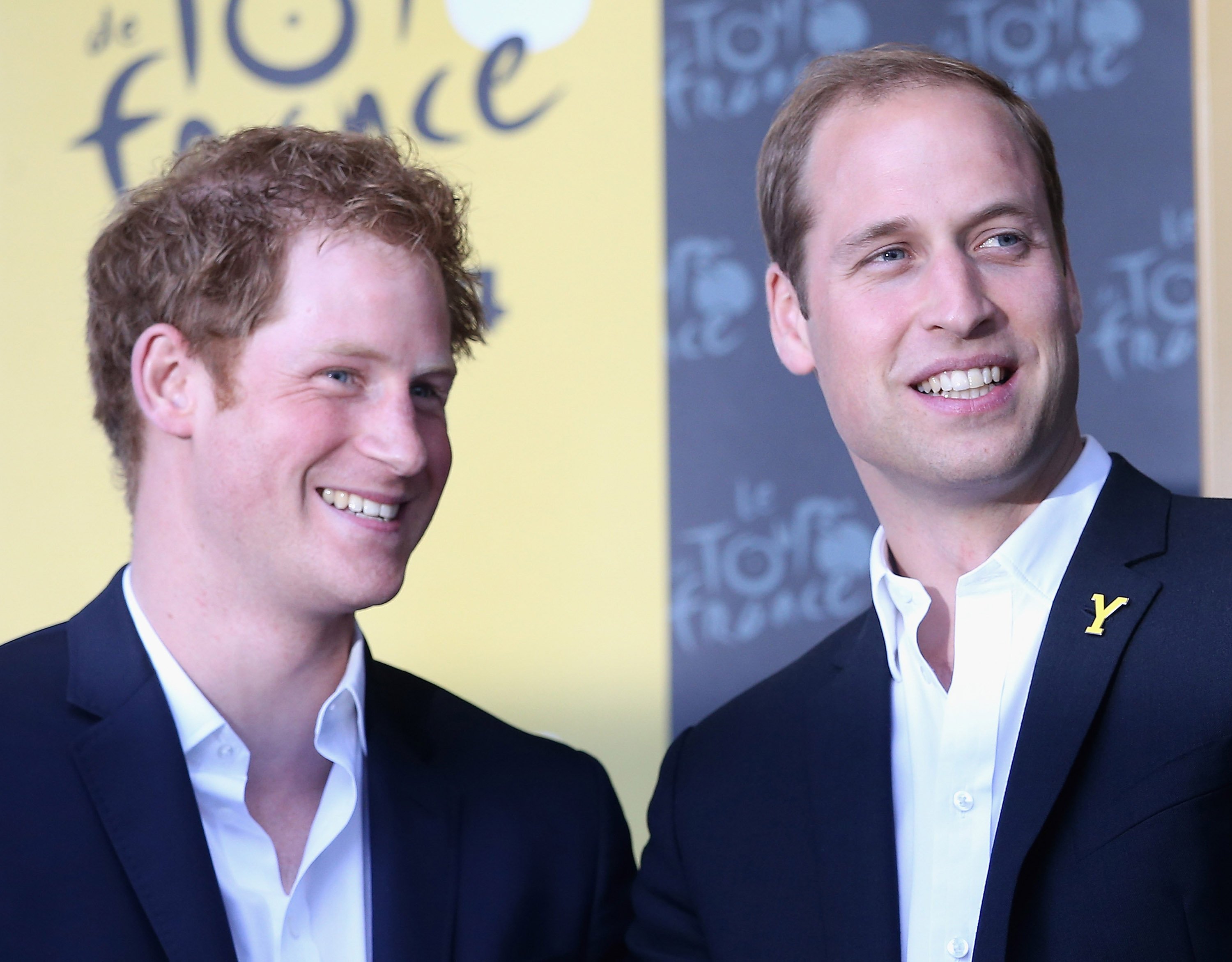 Prince Harry and Prince William pictured laughing together on the podium after Stage 1 of the Tour De France on July 5, 2014 in Harrogate, United Kingdom. / Source: Getty Images