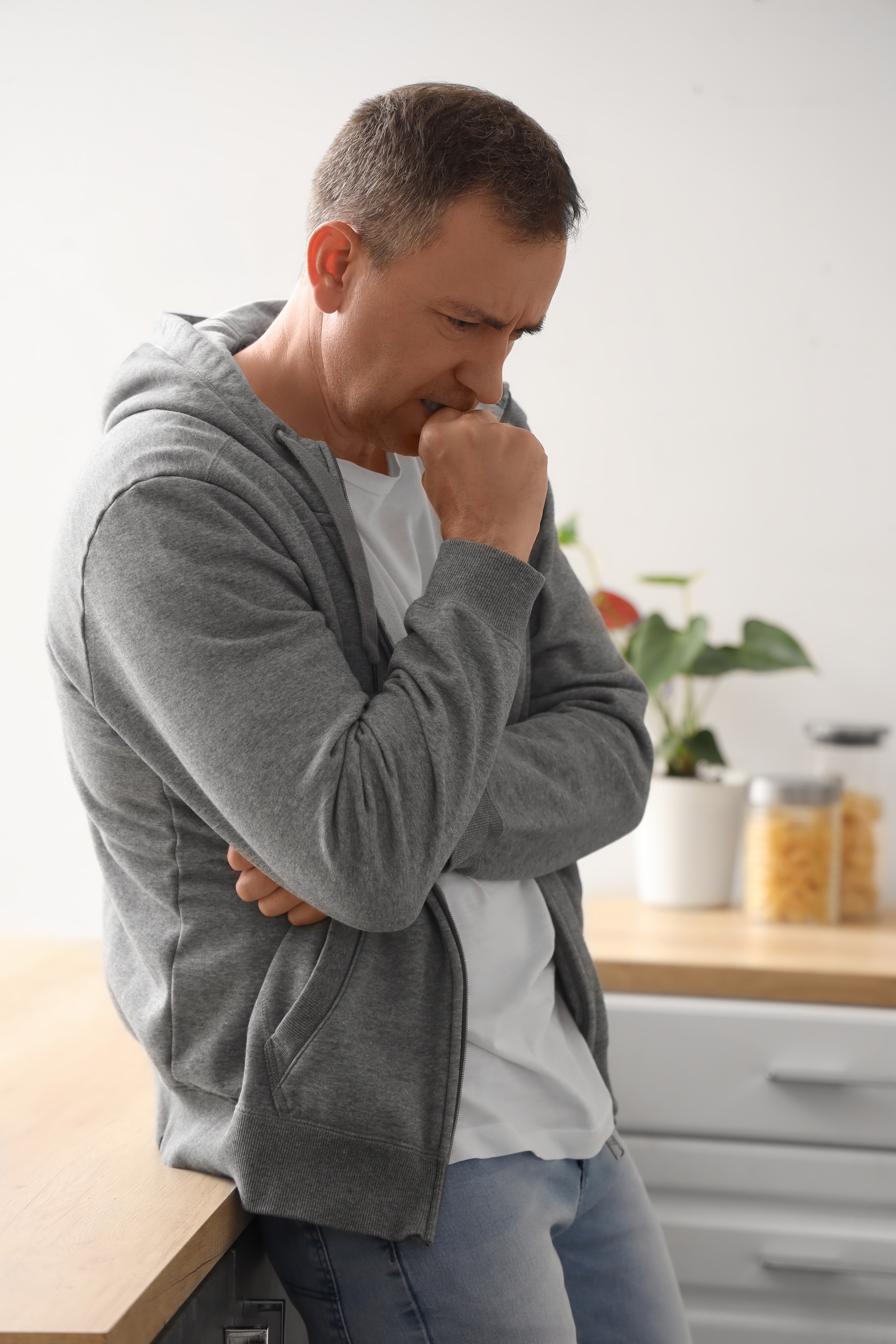 Mature man having panic attack in kitchen. | Source: Shutterstock