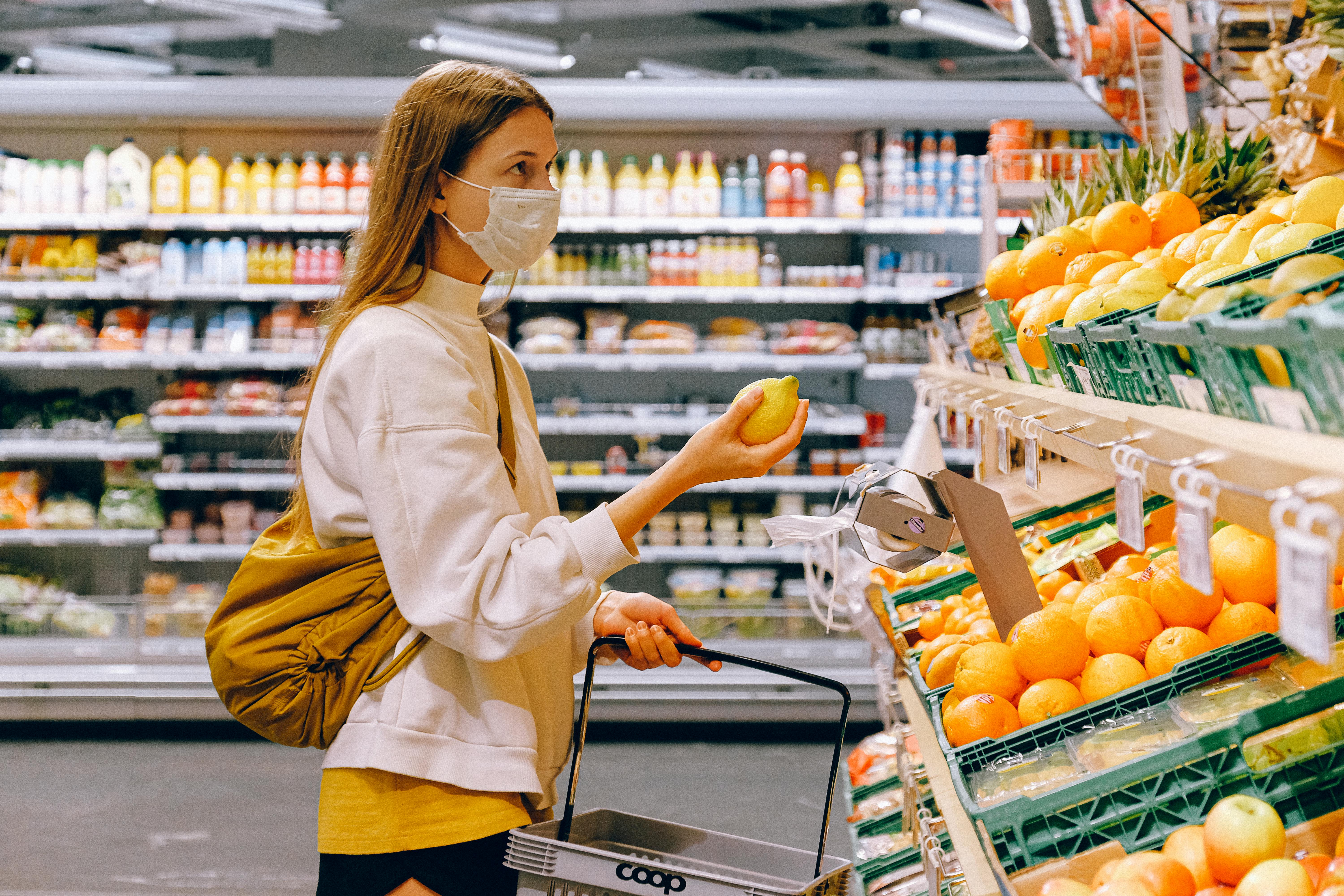 A woman choosing produce at the grocery store | Source: Pexels