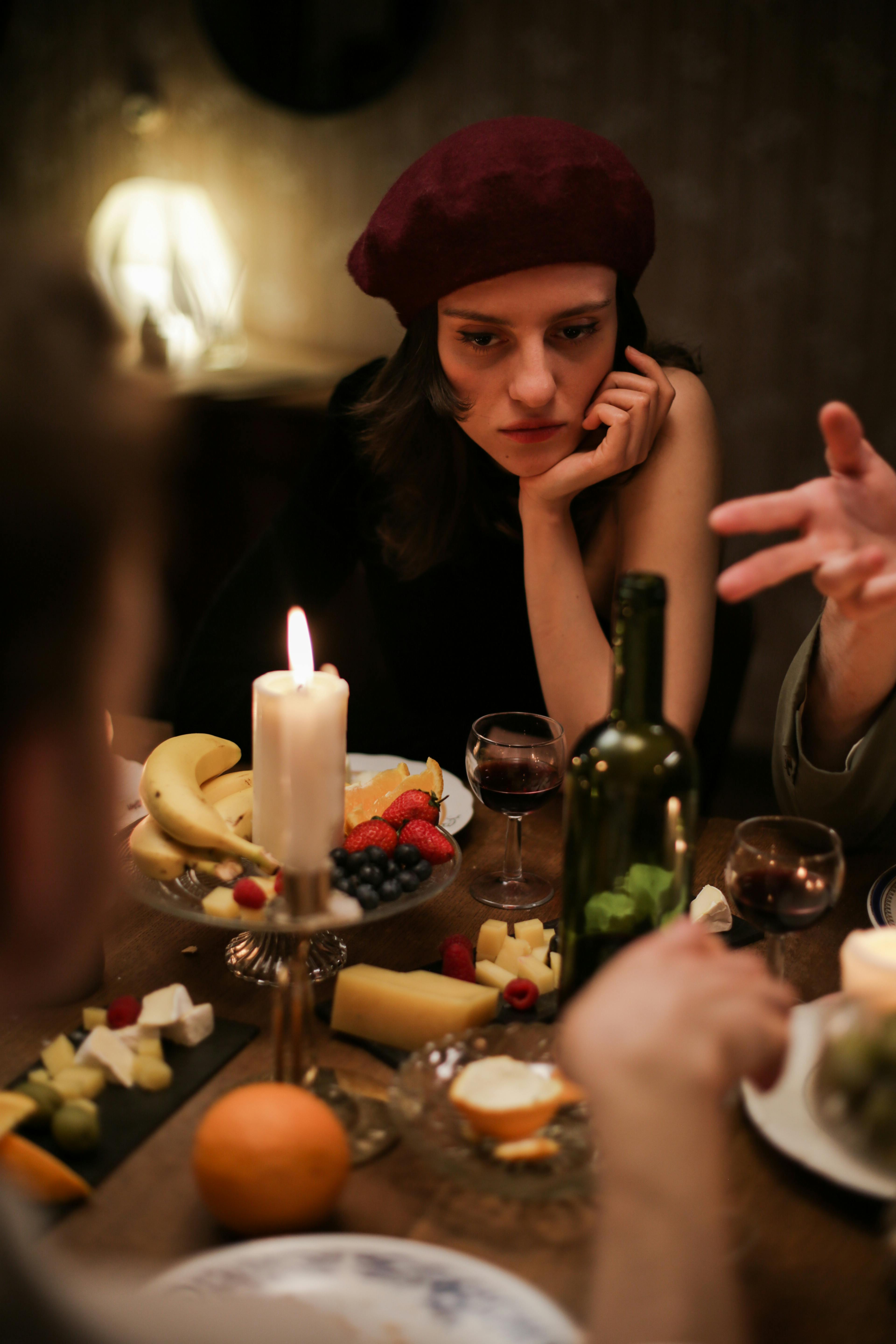 A woman expressing unhappiness at the dinner table | Source: Pexels