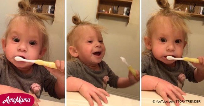 Cute girl pretends her toothbrush is electric to copy dad
