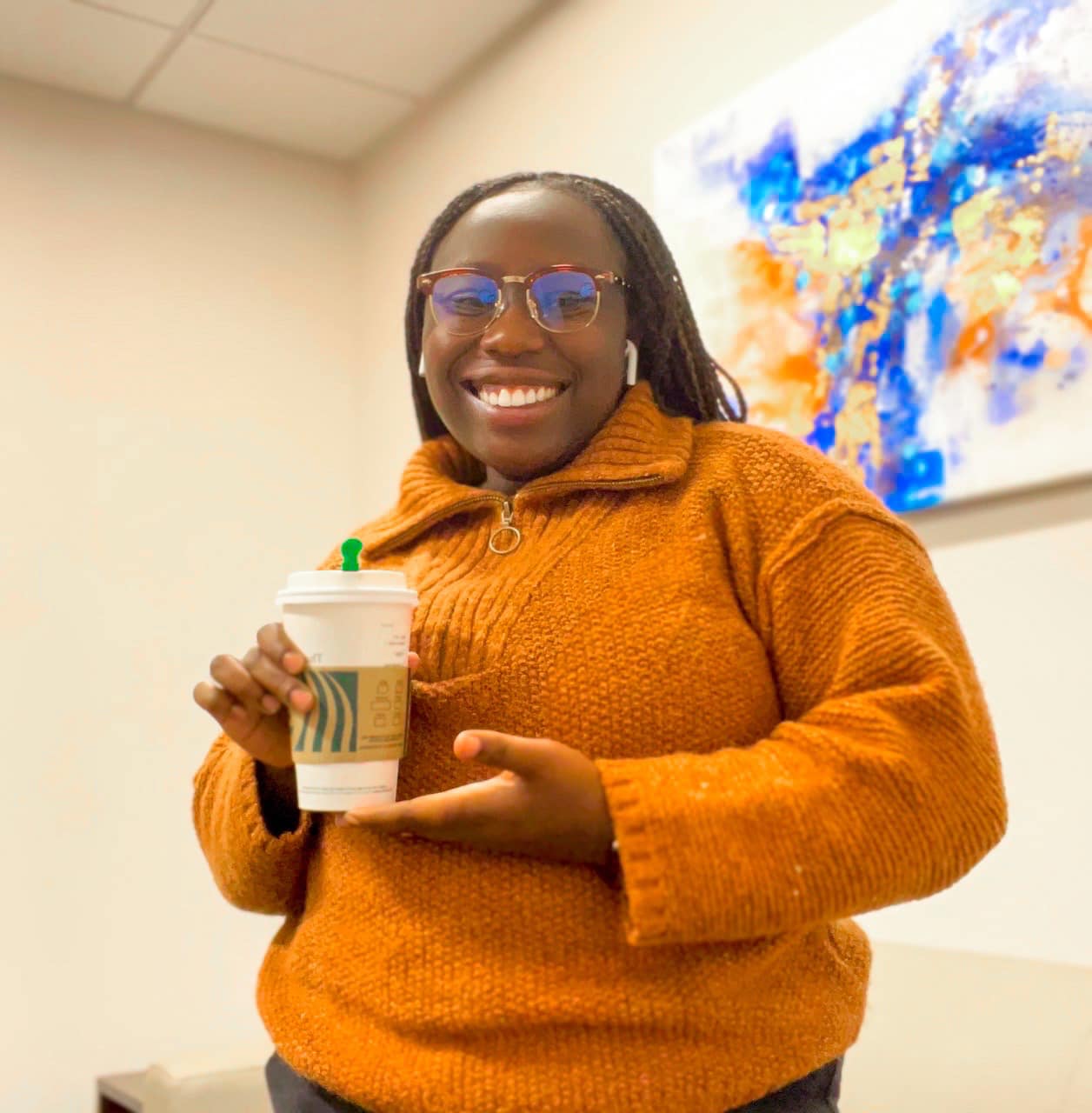 Riziki Ilenre posing with a Starbucks to-go cup at the Chicago-Kent Law Library, from a post dated October 19, 2022 | Source: Facebook/Riziki Ilenre
