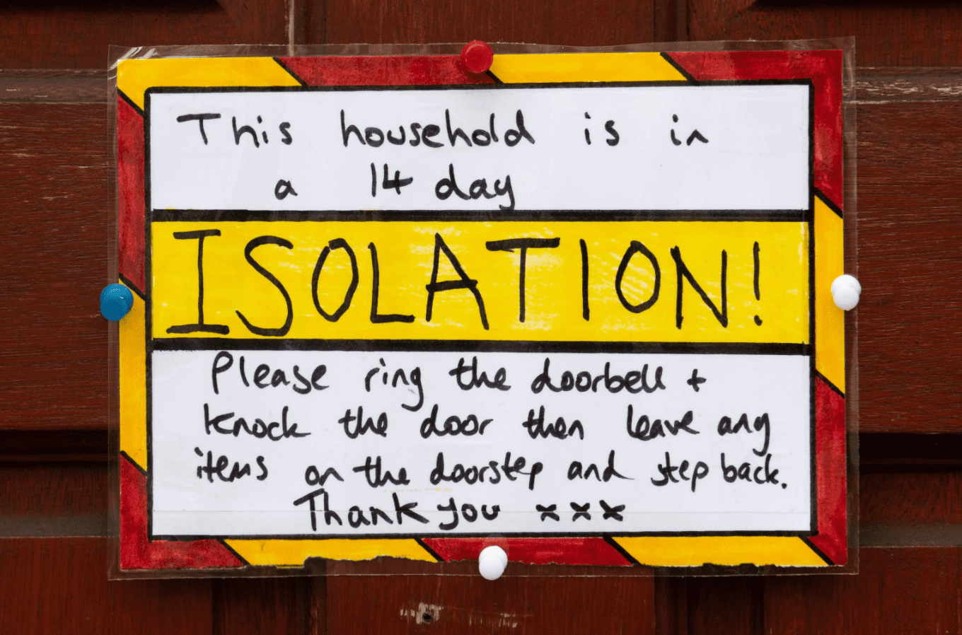  A sign on the door of a residential property where the household are in a 14 day isolation in accordance with new government guidelines on March 18, 2020 in Cardiff, United Kingdom. | Source: Getty Images