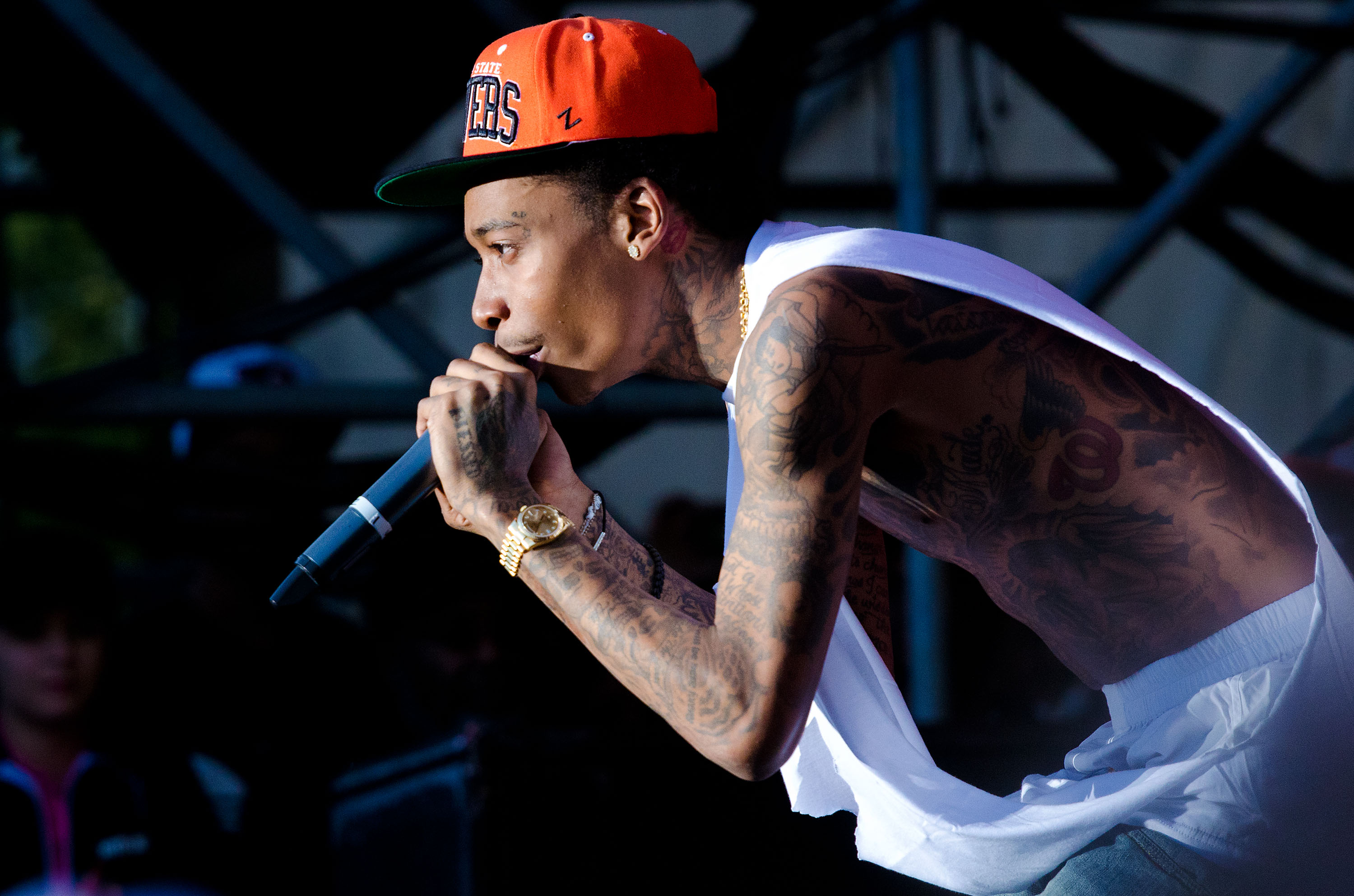 Wiz Khalifa leans into the crowd while performing at the 4th Annual Roots Picnic at Festival Pier in Philadelphia, Pennsylvania, on June 4, 2011. The rapper's slender, tattoo-covered frame was still a defining part of his image at the time, years before MMA training helped him add significant muscle and transform his appearance.